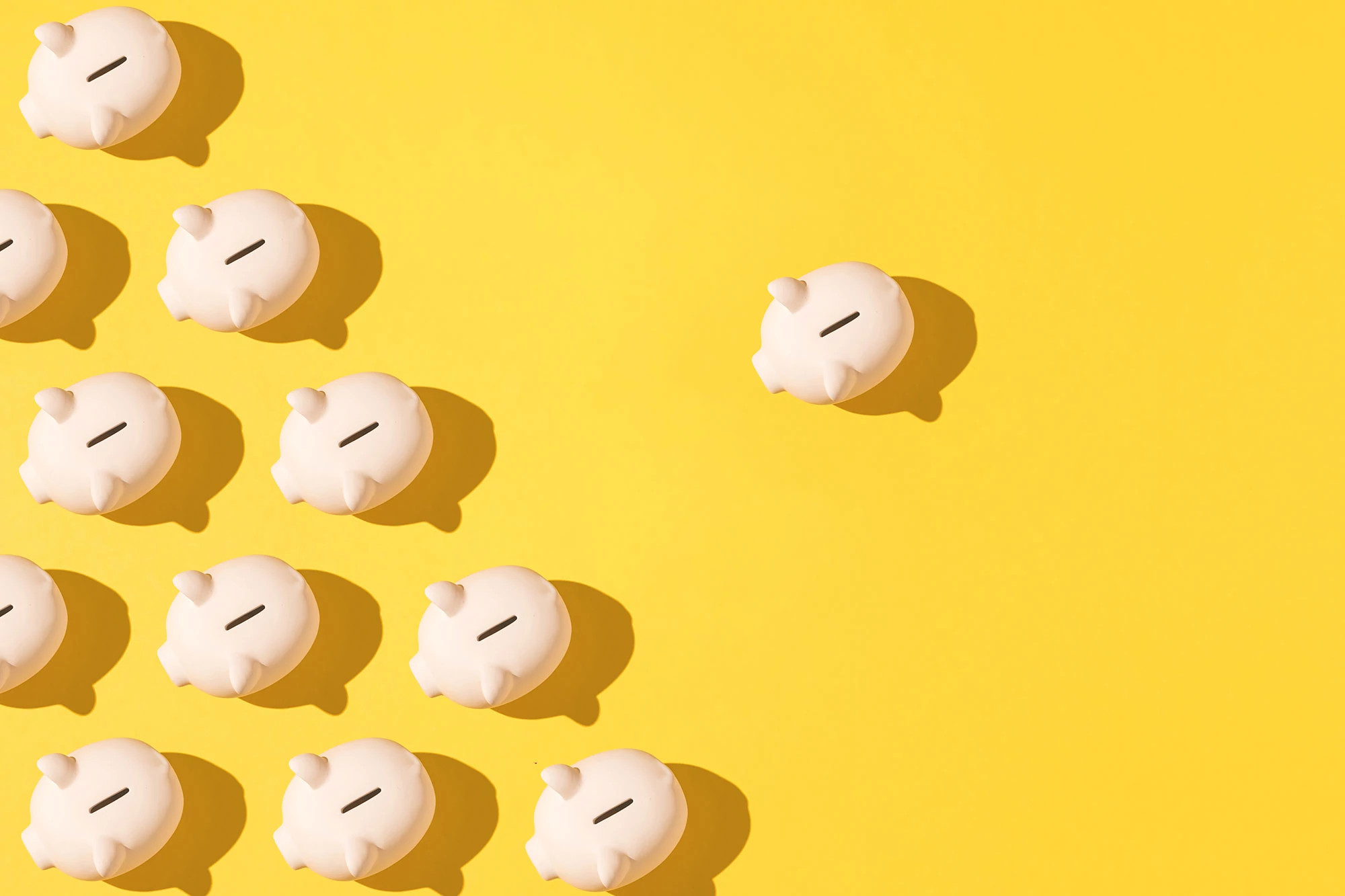 Piggy banks patterned on yellow background