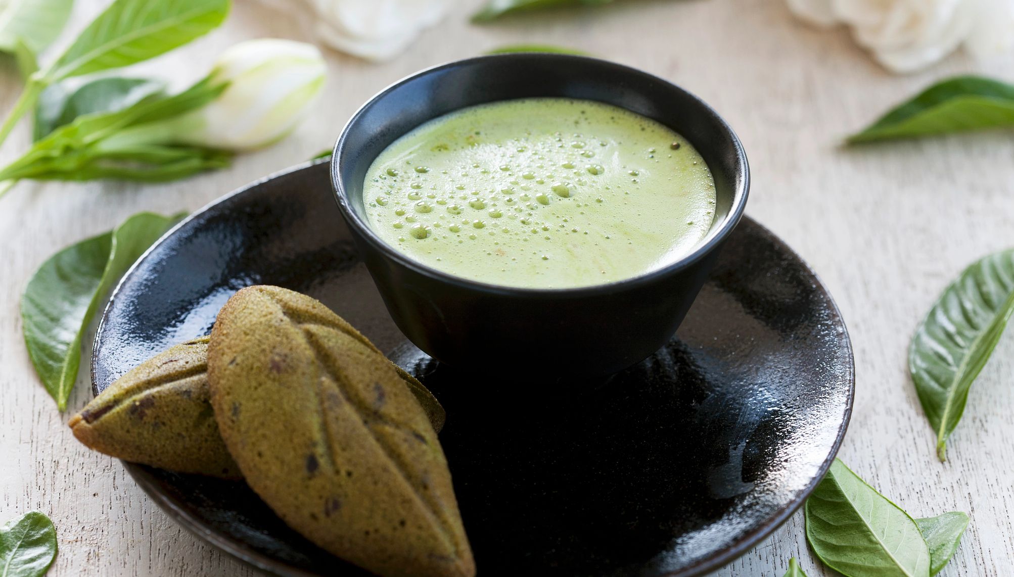 matcha in a cup with cookies
