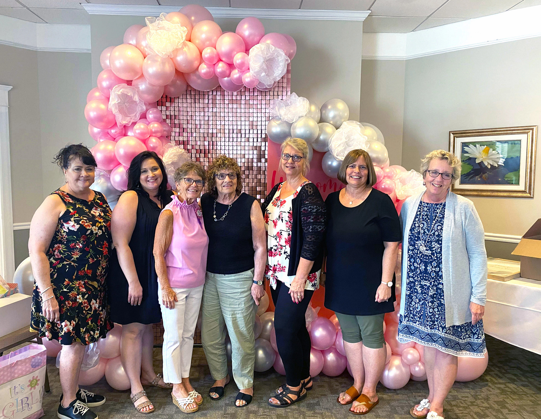 a photo shows Susie Rhinehart and other older adult women at a grandmother shower