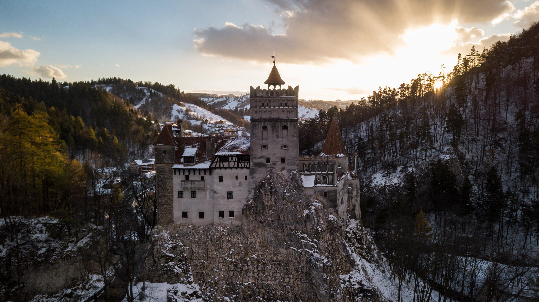 bran castle in romania covered in snow