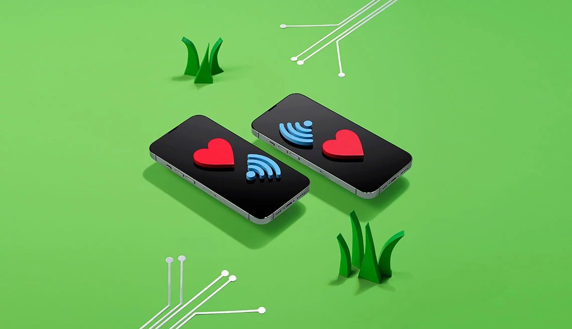 Stay Connected With Tech From a ¾ perspective two smart phones are shown in a digital illustration on a green background. Each phone is displaying a heart emoji and a Wi-Fi connection symbol. Two separate sets of white connecting wires are approaching the phones.