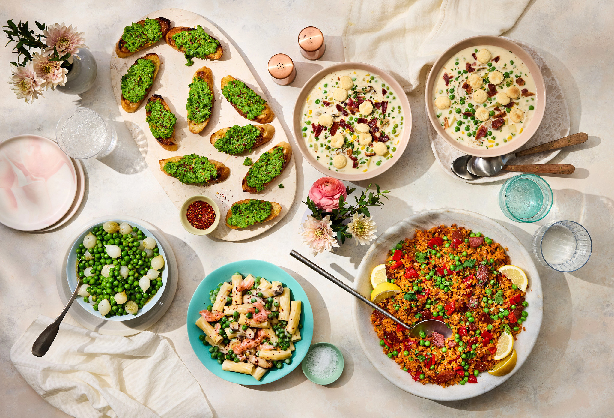 a photo shows an overhead view of the dishes featured in this article on dinner table with a white tablecloth