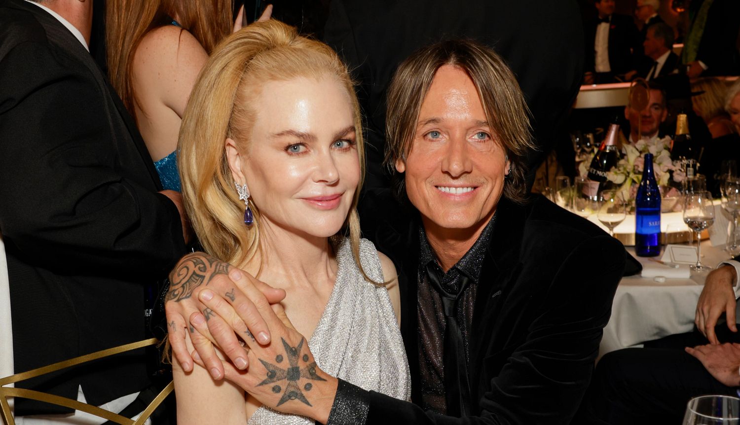 Nicole Kidman, Keith Urban Split a photo shows Keith Urban seated with his arms around Nicole Kidman at a celebrity event