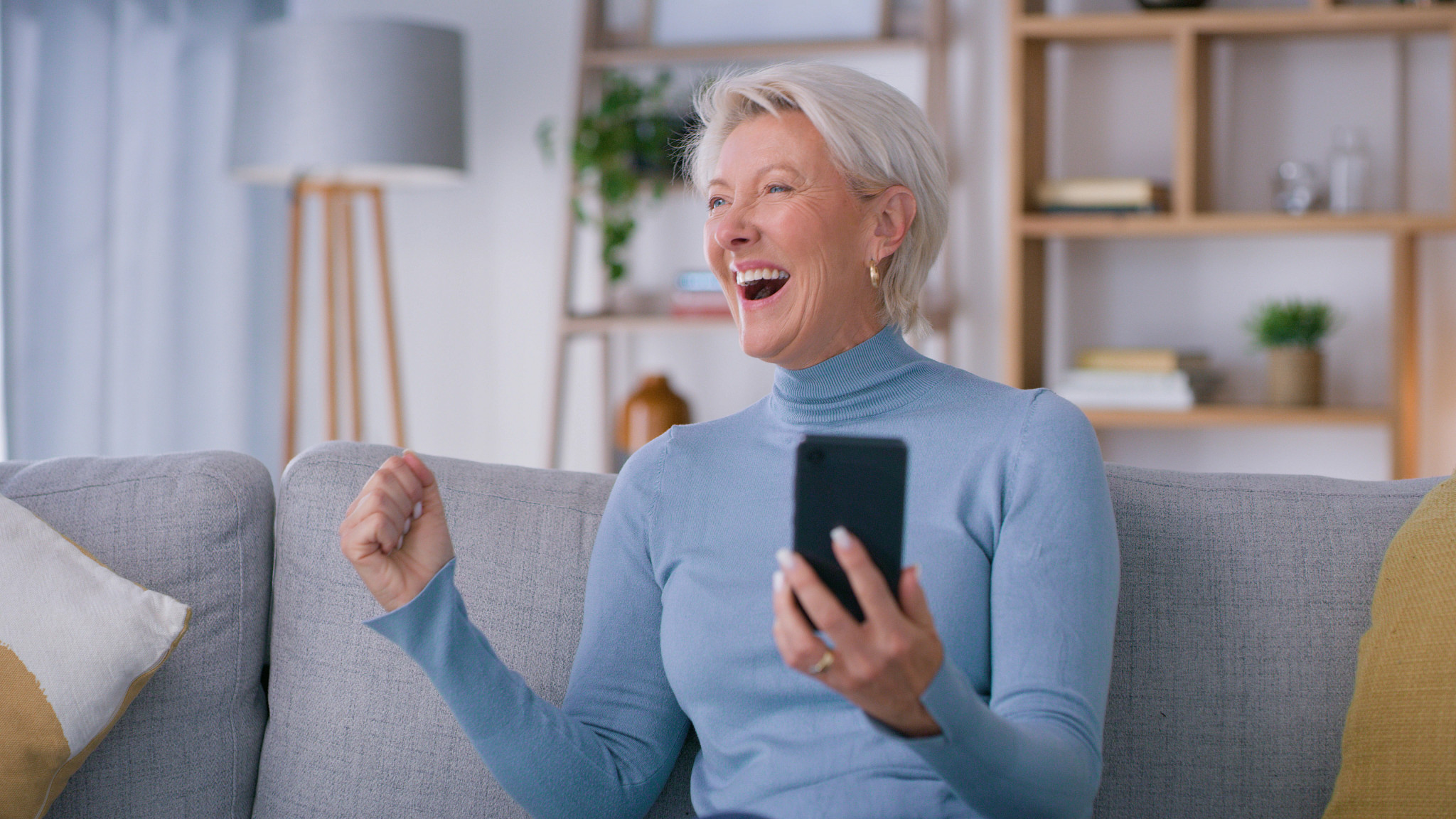 Happy elderly female excited for promotion