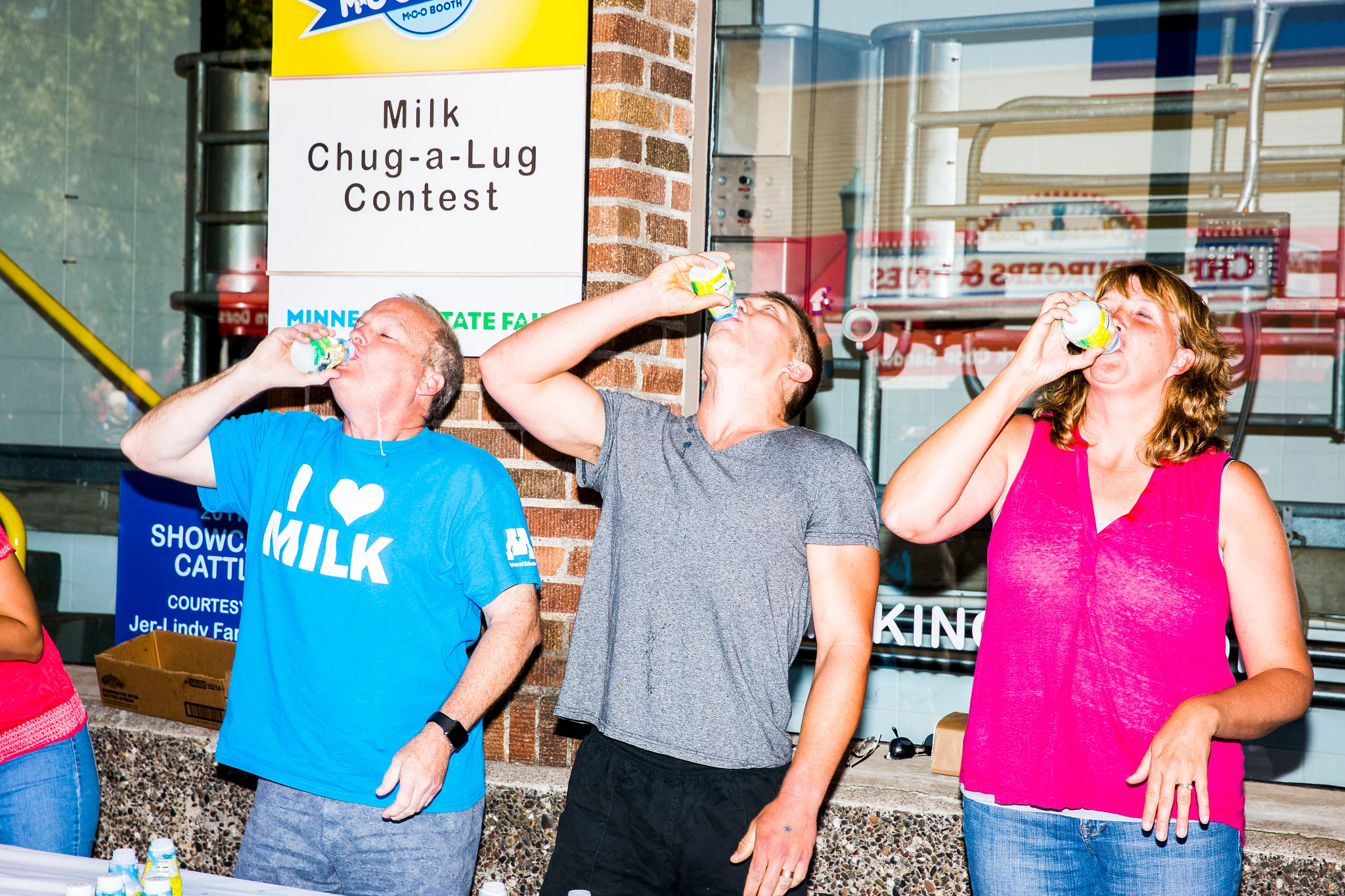 three people drinking milk at the Minnesota State Fair