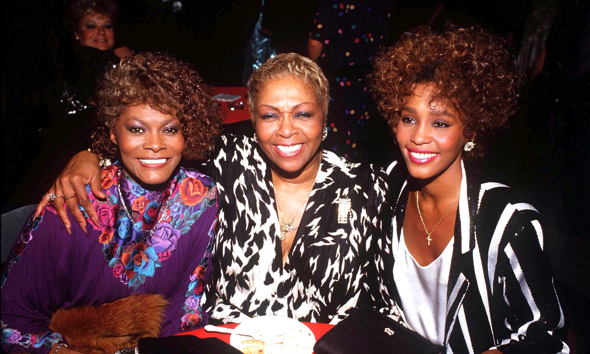 Gospel singer Cissy Houston sitting with Whitney Houston and Dionne Warwick after the American Music Awards at the Shine Auditorium in Los Angeles