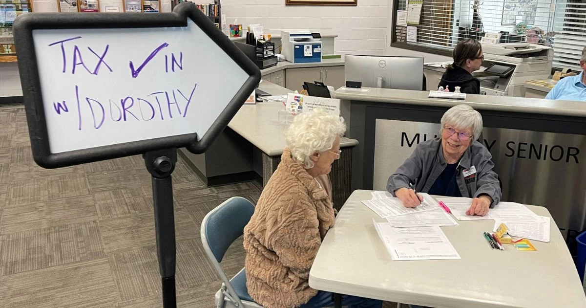 Tax-Aide volunteer, Dorothy, checking people in at the Sandy, Utah Tax-Aide location.