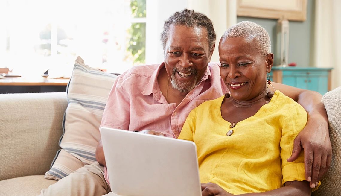 Take the Senior Healthy Living Survey online A couple sitting on a sofa at home and using a laptop