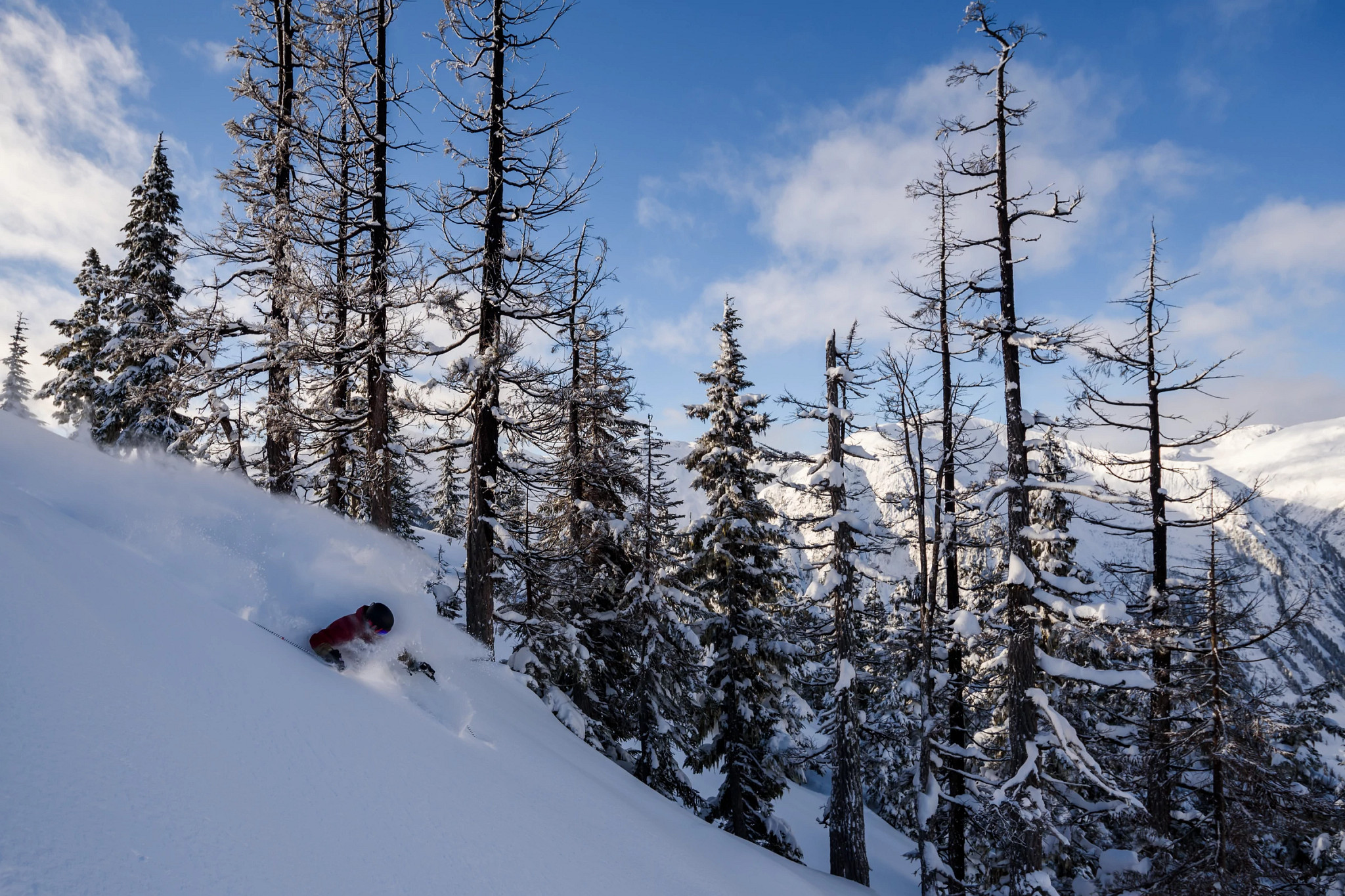 a person skiing through thick snow on a mountainside