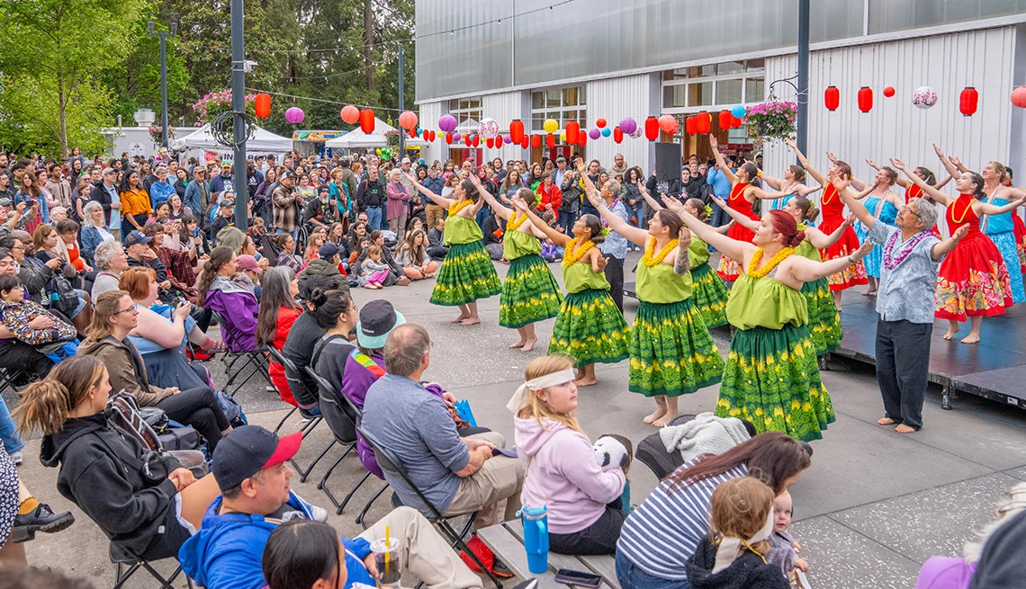performers stand in front of a crowd during an event