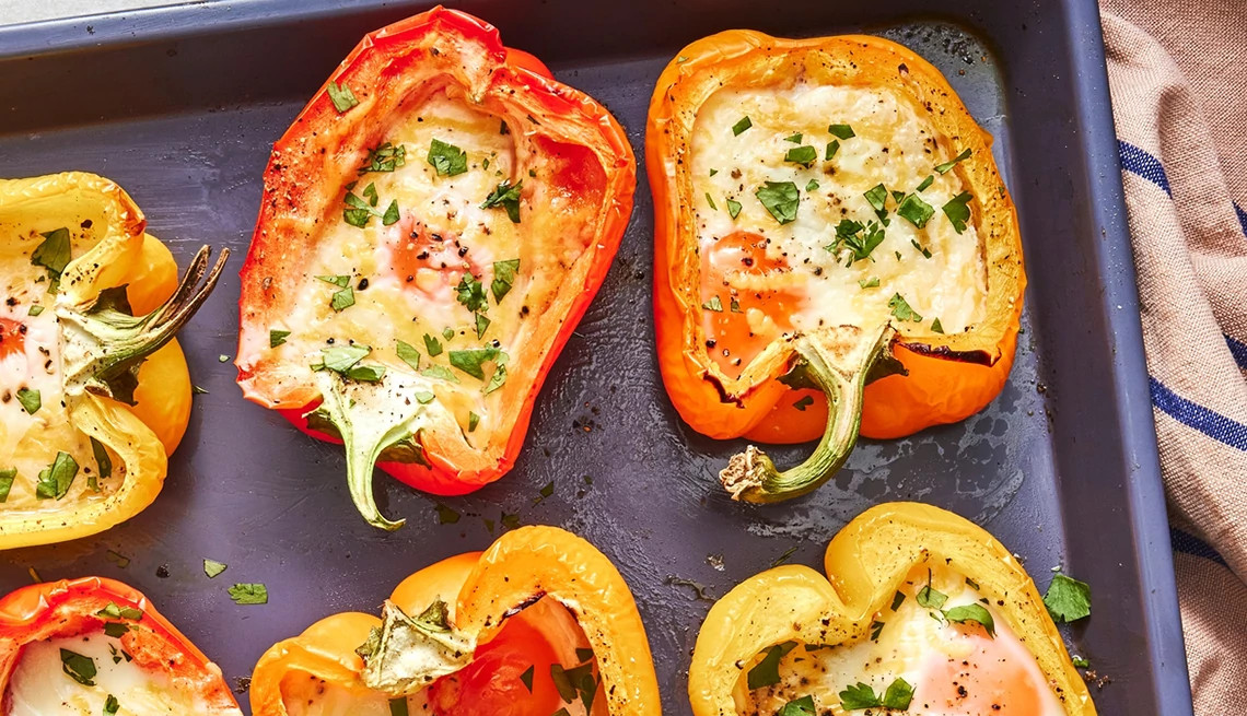 A close-up view of three-ingredient bell pepper and cheese egg cups on a sheet pan