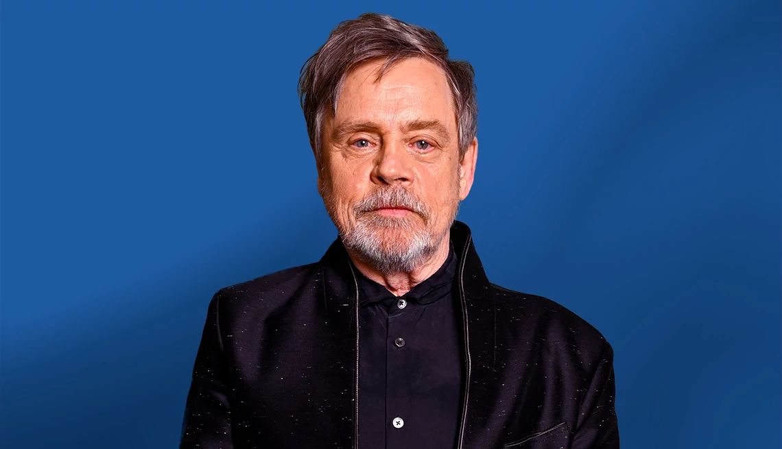 At 73, Mark Hamill Doesn’t Sweat the Small Stuff Mark Hamill posing for a portrait in front of a blue background