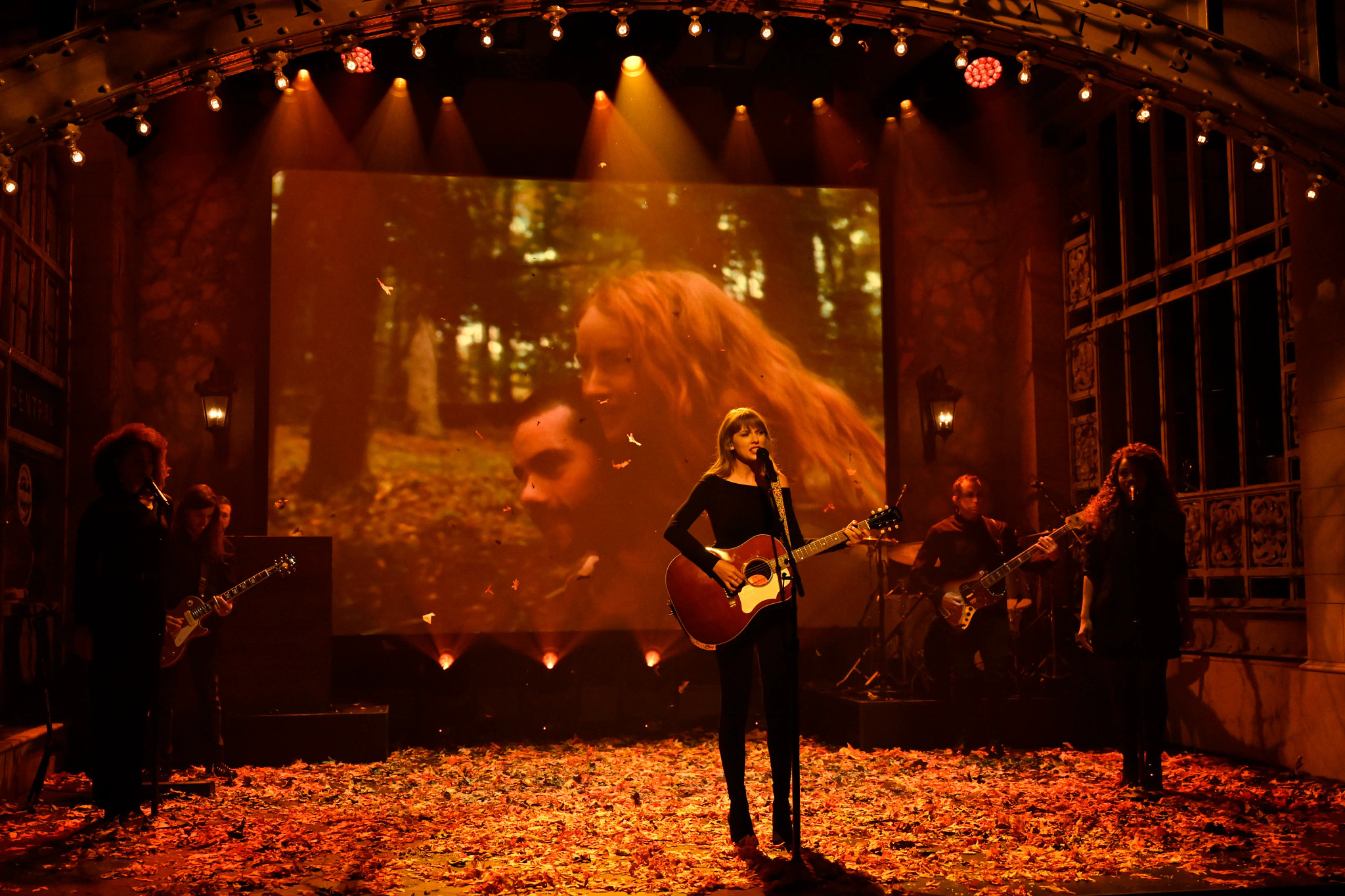 Taylor Swift playing the guitar during her performance on Saturday Night Live