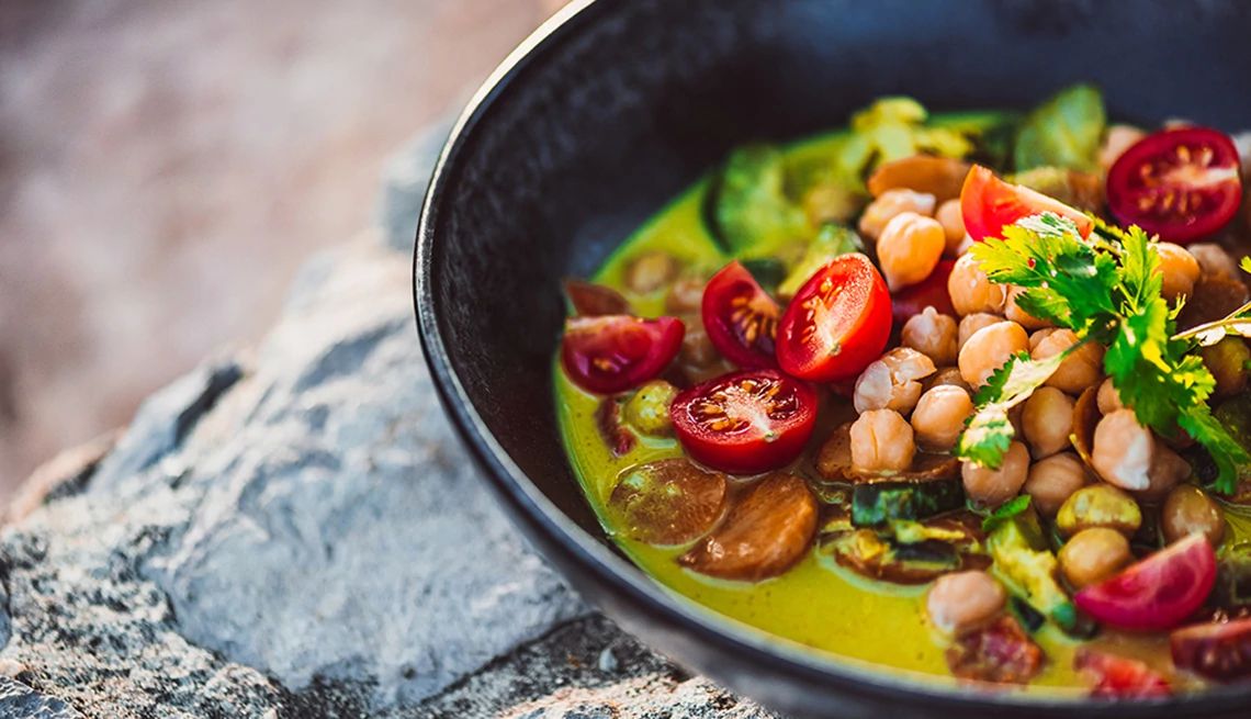 Plant-based diets may be better for your overall health A close up of Asian green curry with coconut milk in a pan