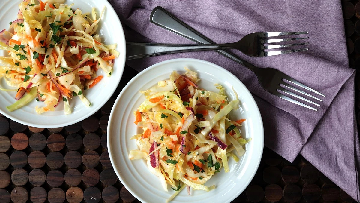 A close-up view of vinegary coleslaw on plates