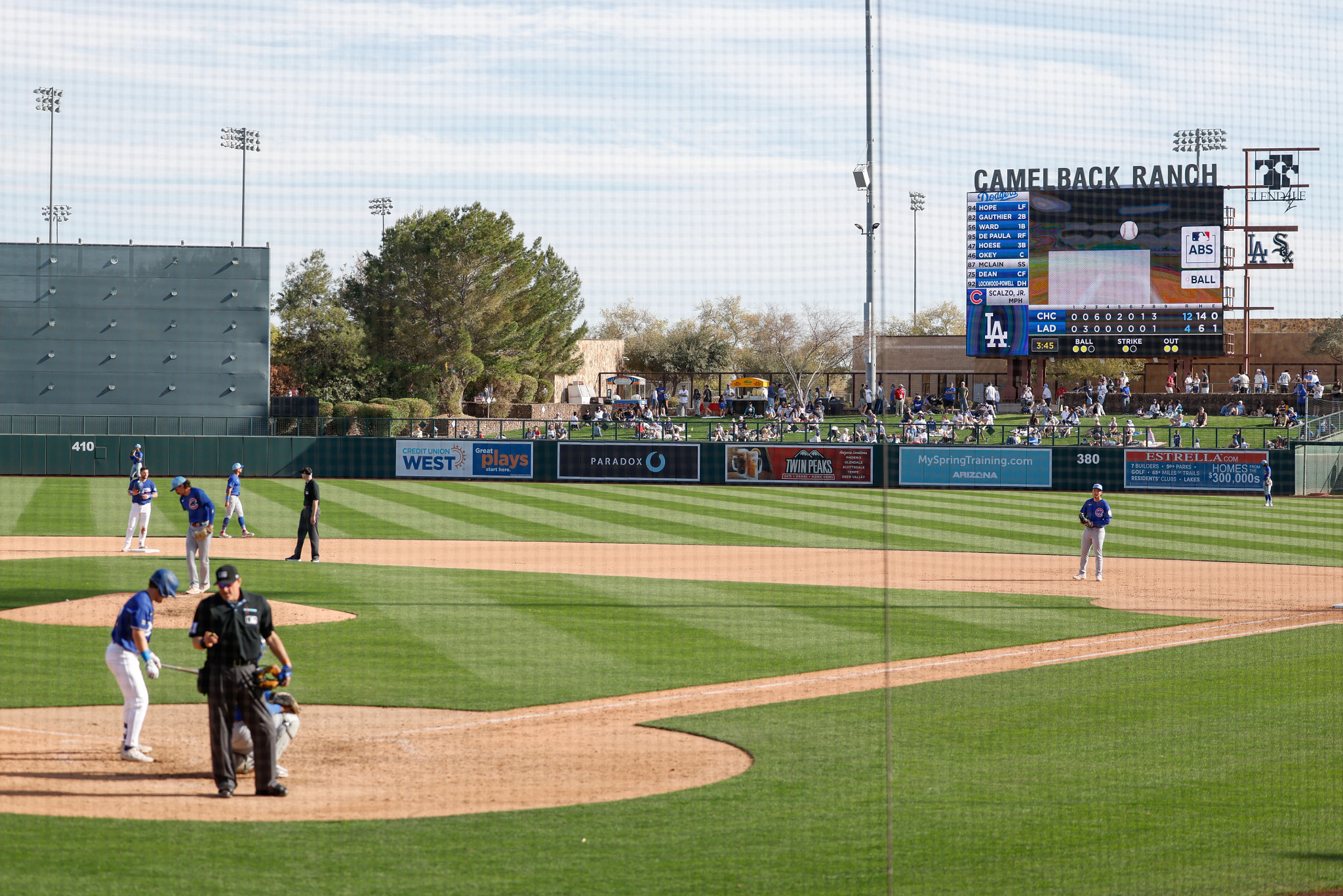 a photos shows umpire Tony Randazzo utilizing the automated ball-strike challenge system during a spring training game in 2025