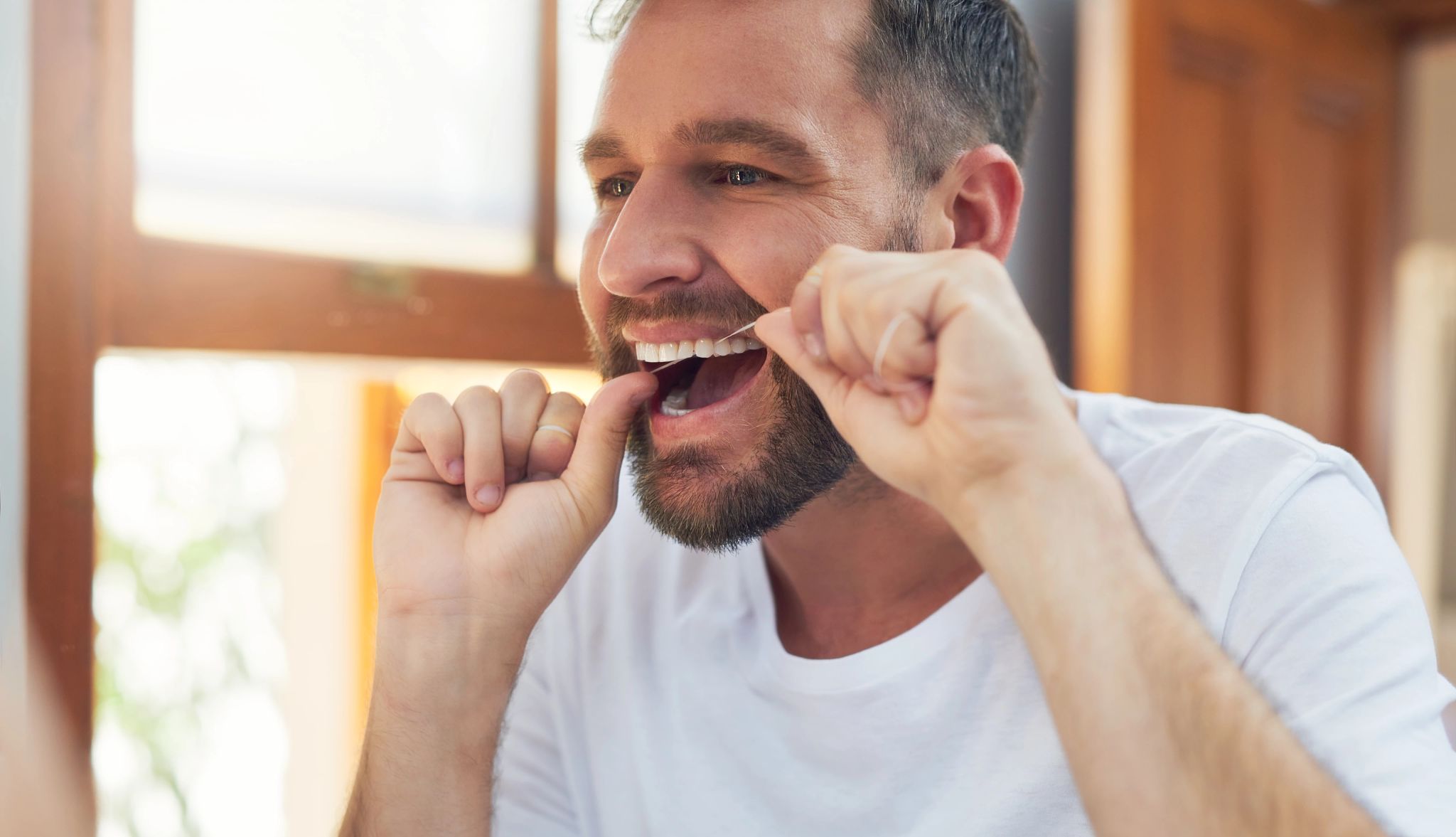 Flossing Your Teeth Cuts Stroke Risk man flossing