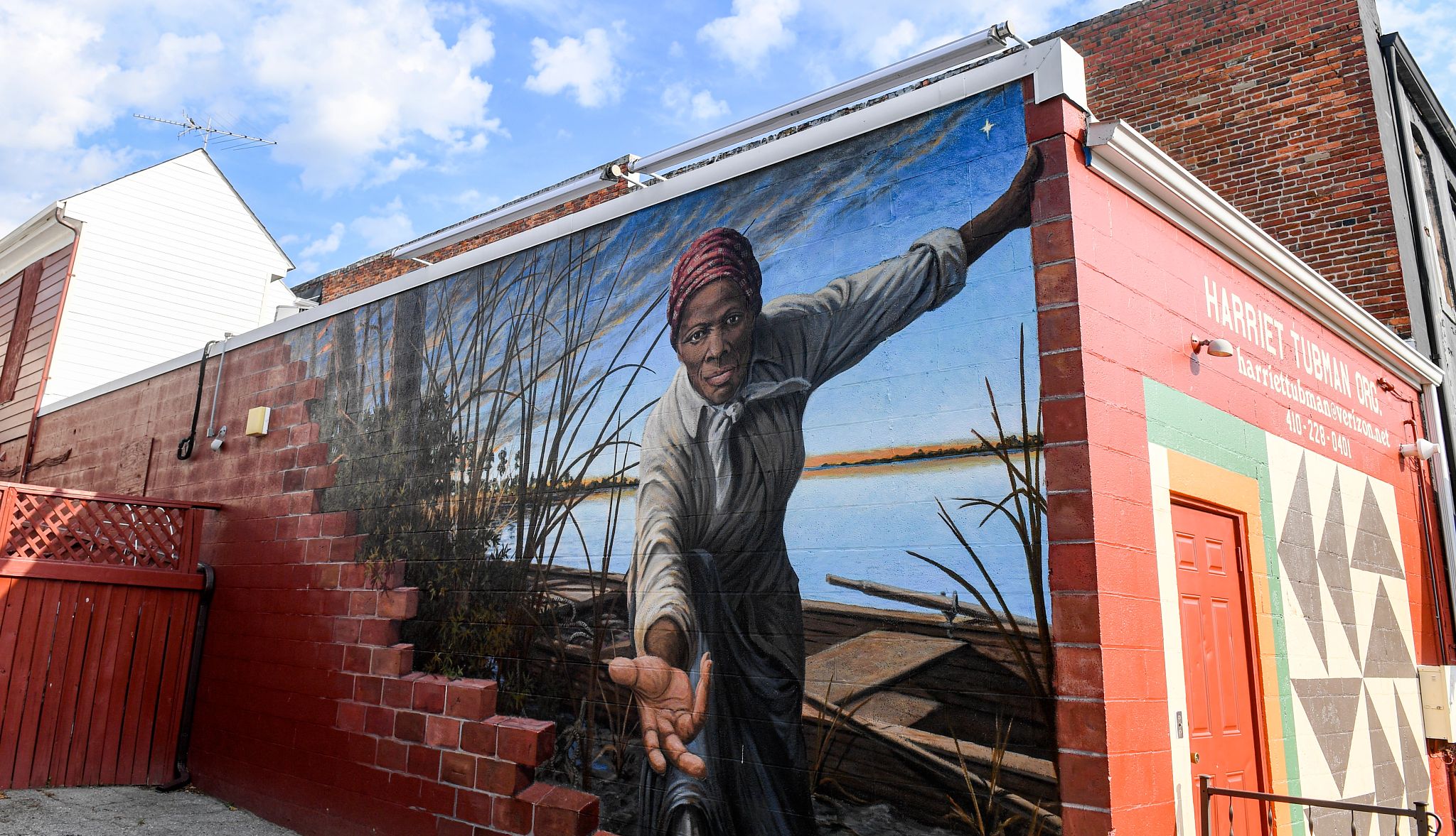 The "Take My Hand" mural of Harriet Tubman in Cambridge, MD Mural of Harriet Tubman reaching out her hand on side of building
