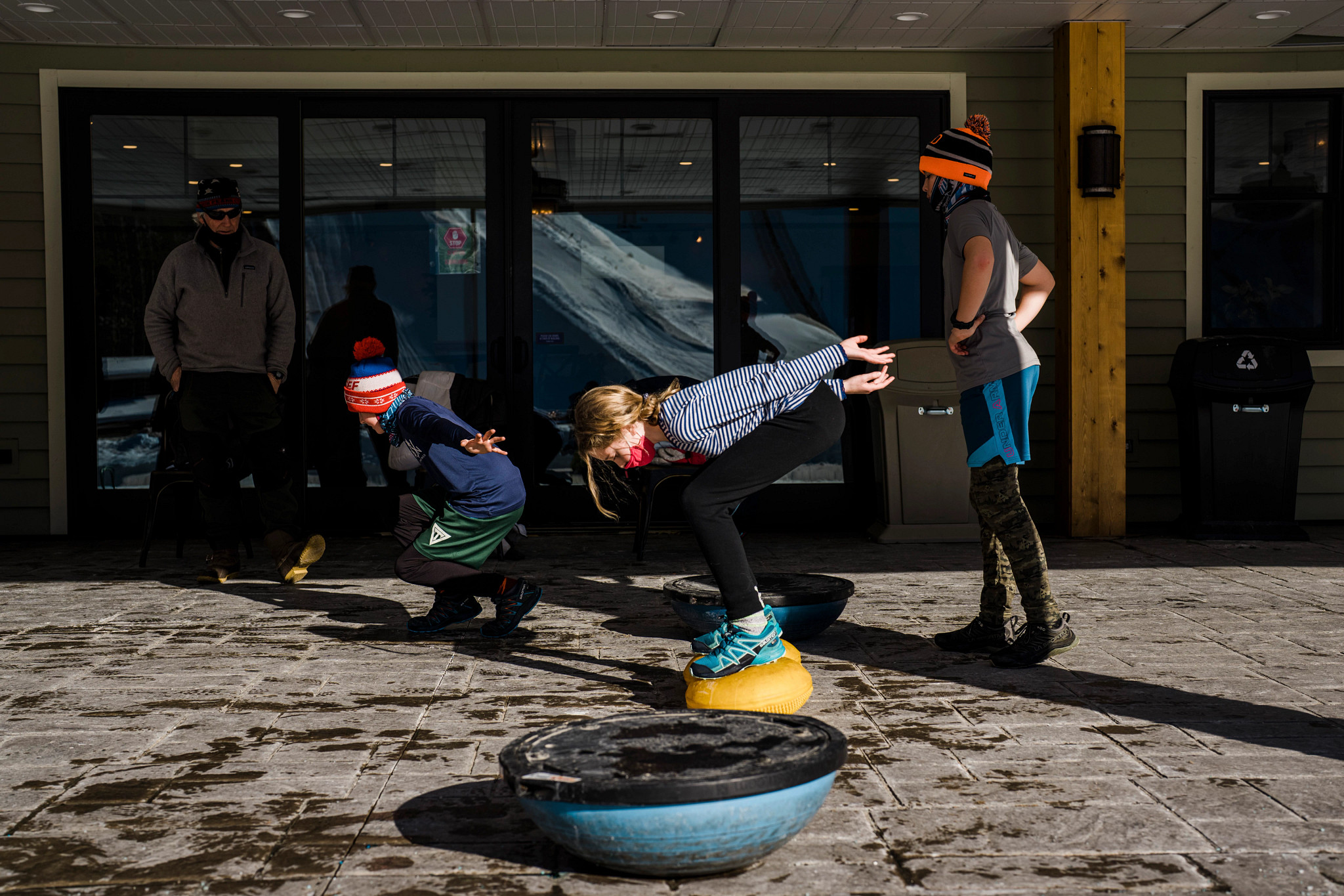 kids practicing skiing outside of a store