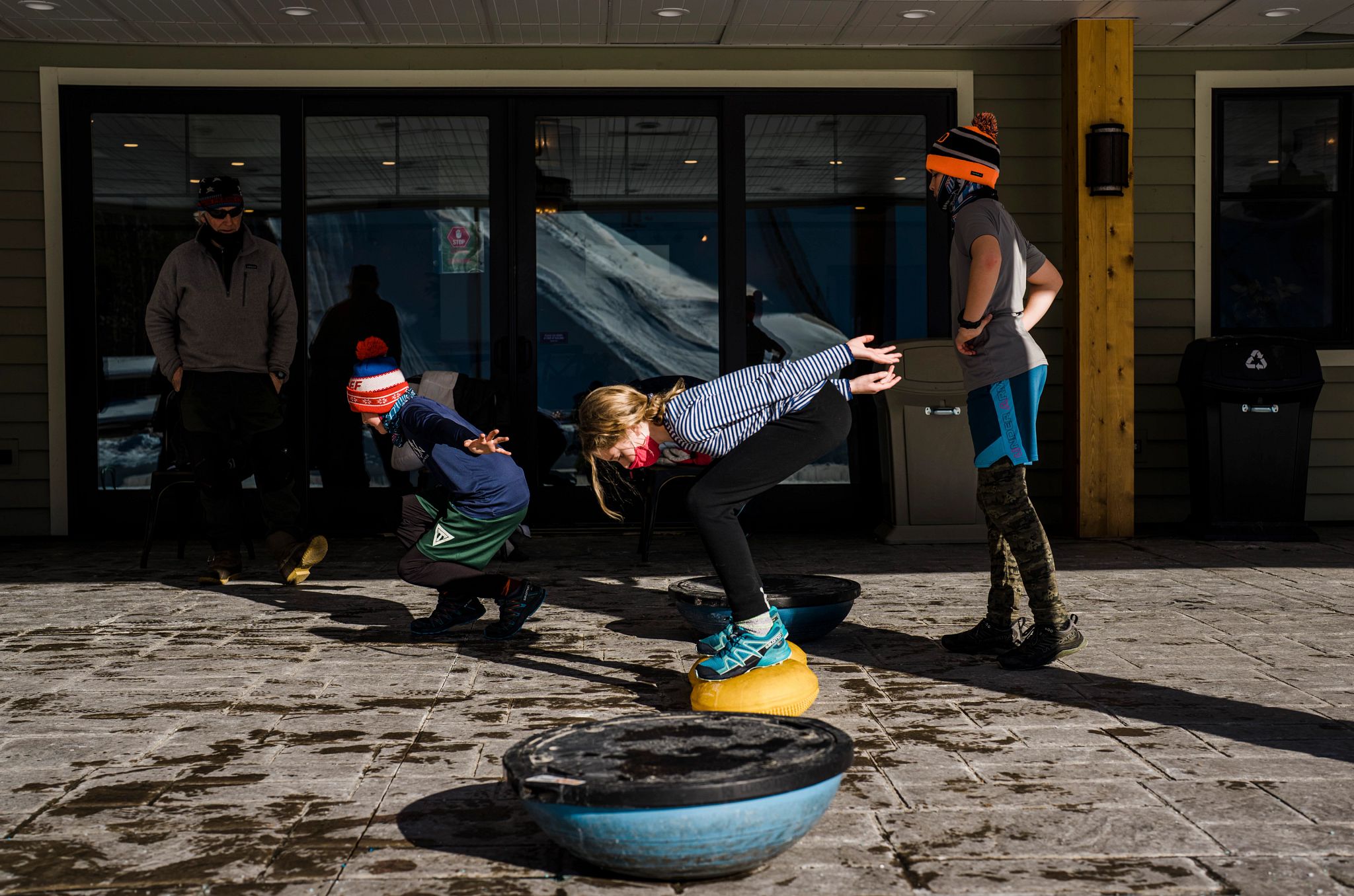 kids practicing skiing outside of a store
