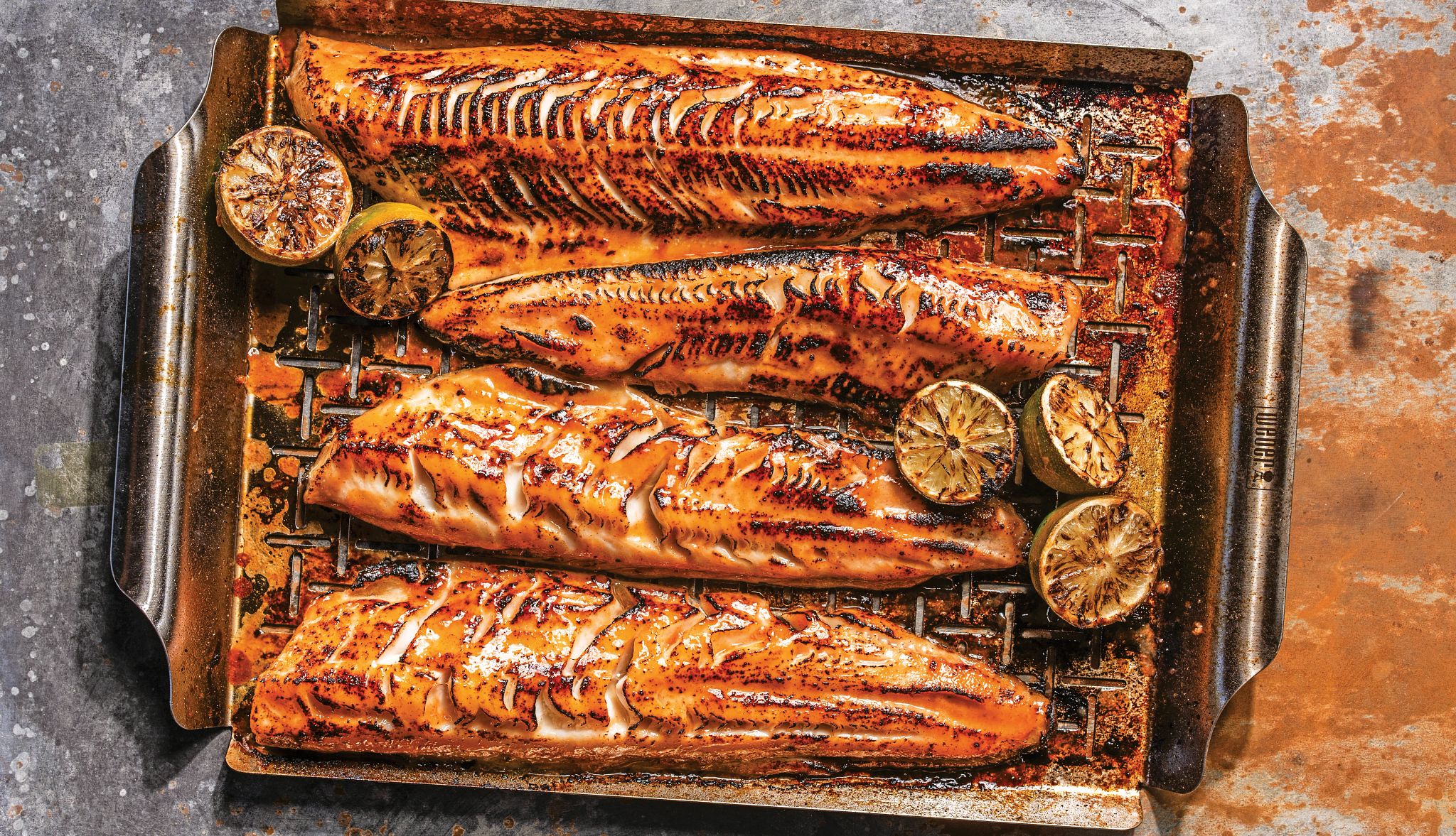 Recipe: Michael Symon's Spicy Black Cod with Grilled Lime grilled black cod with grilled lime halves in a metal pan
