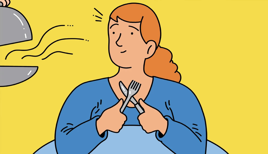 a person holding a fork and spoon waiting on food