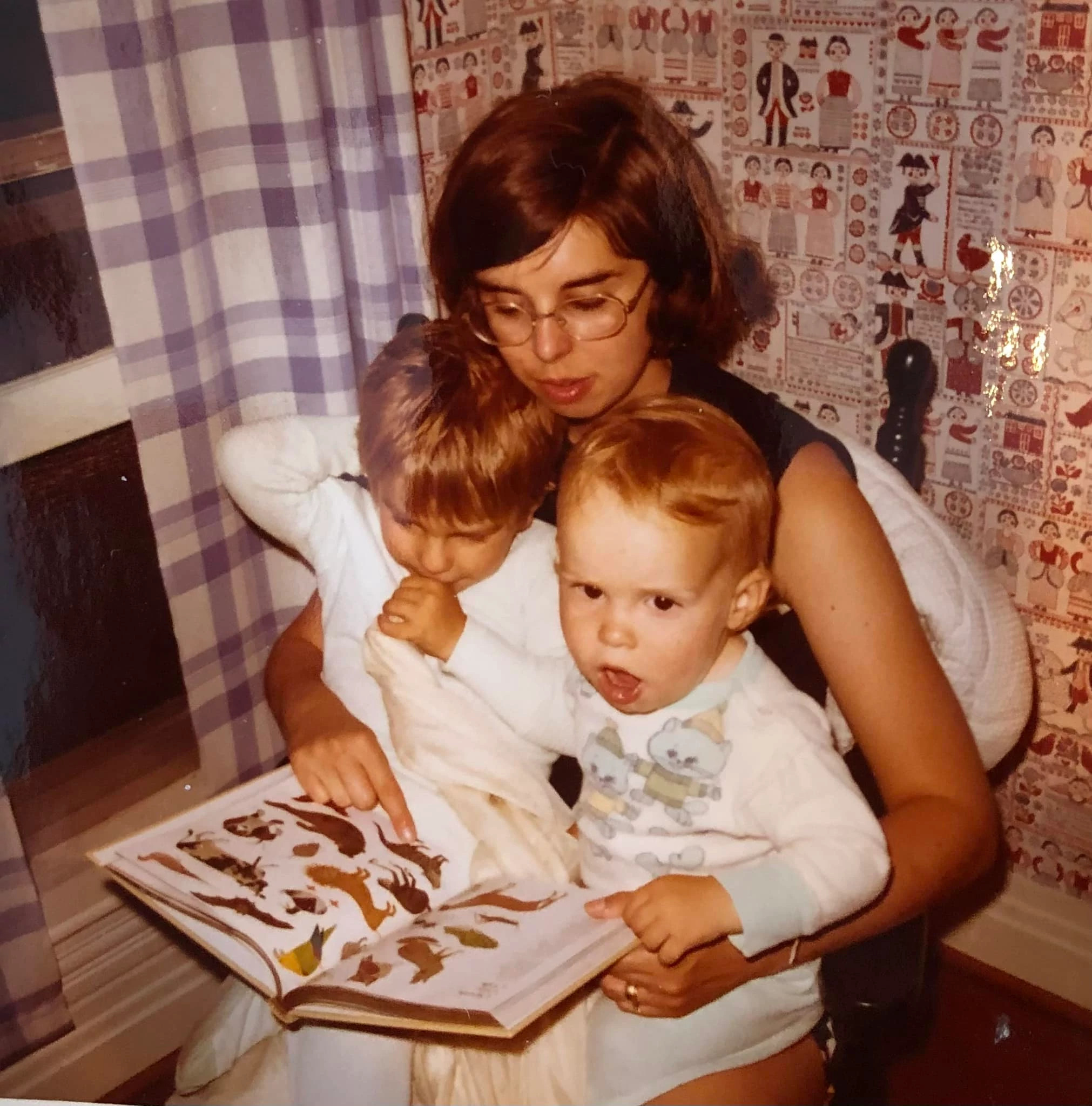 a photo shows writer eric spitznagel as a child with his brother, sitting in his mother’s lap
