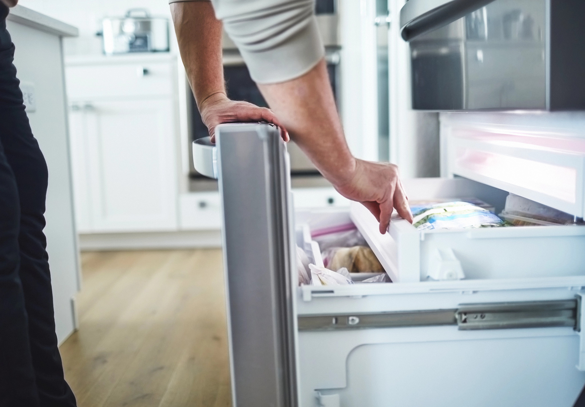 hands loading a dish washer