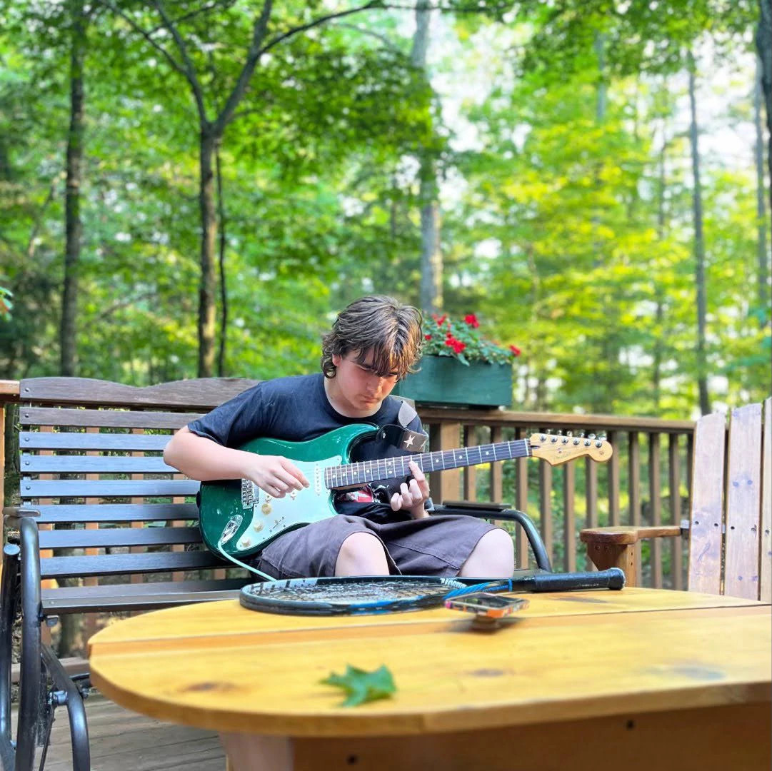 a photo shows author Eric Spitznagel’s son Charlie practicing his guitar as a teen