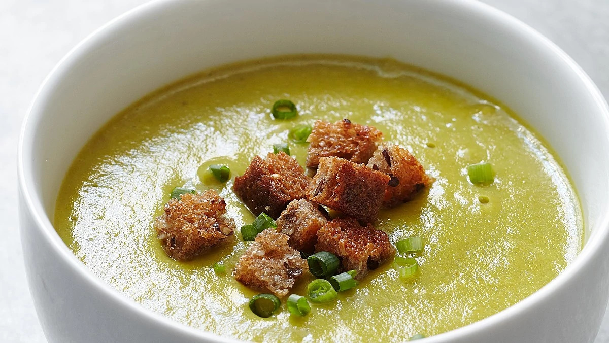 A close-up view of creamy asparagus-potato soup in a bowl
