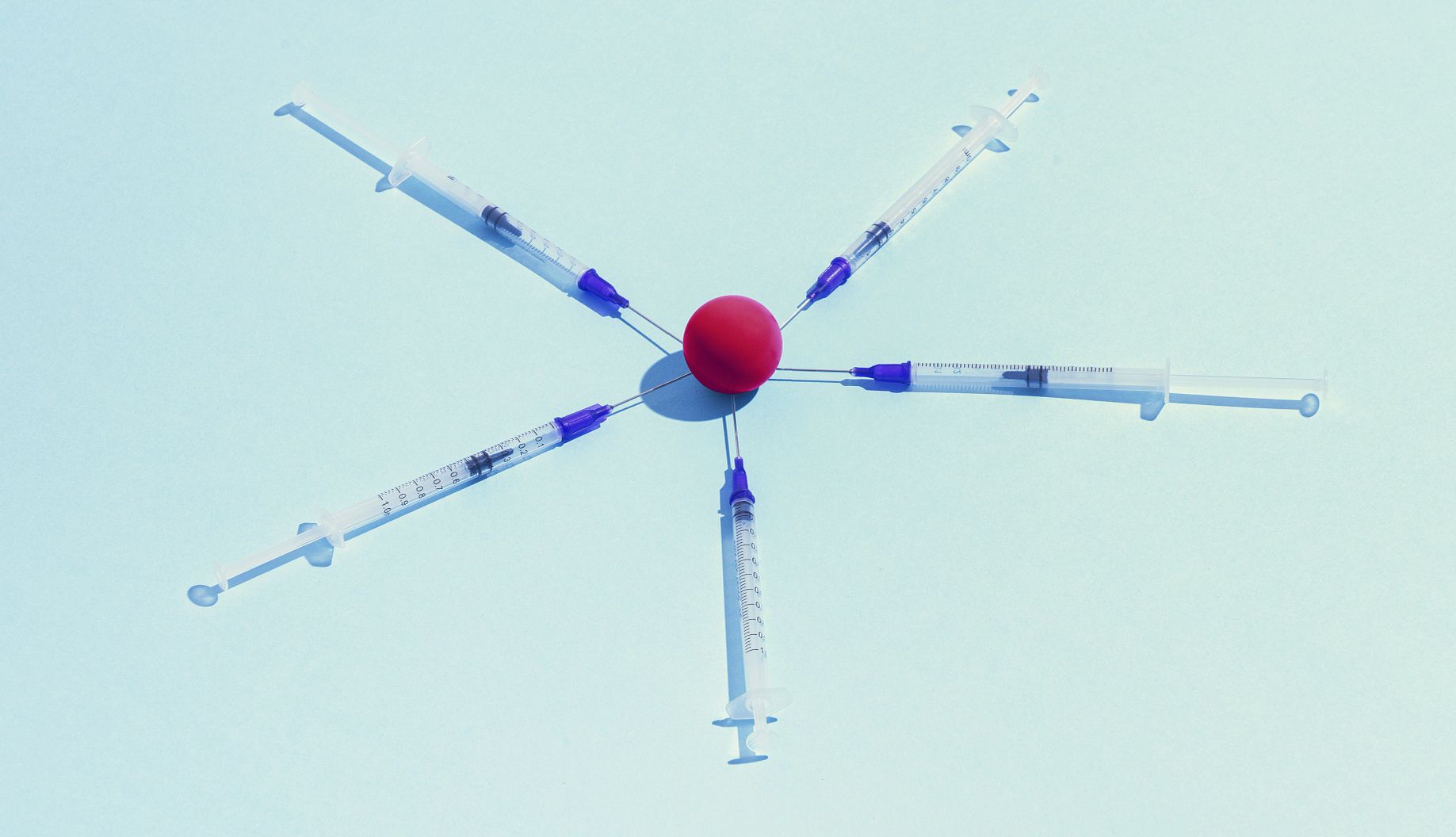 Fall Flu Vaccine Changes vaccination syringes placed around a red sphere