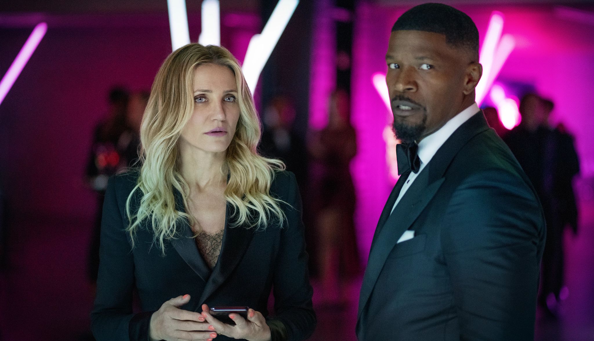 Cameron Diaz and Jamie Foxx in Back in Action Cameron Diaz holding a smartphone next to Jamie Foxx in a scene from the Netflix film Back in Action