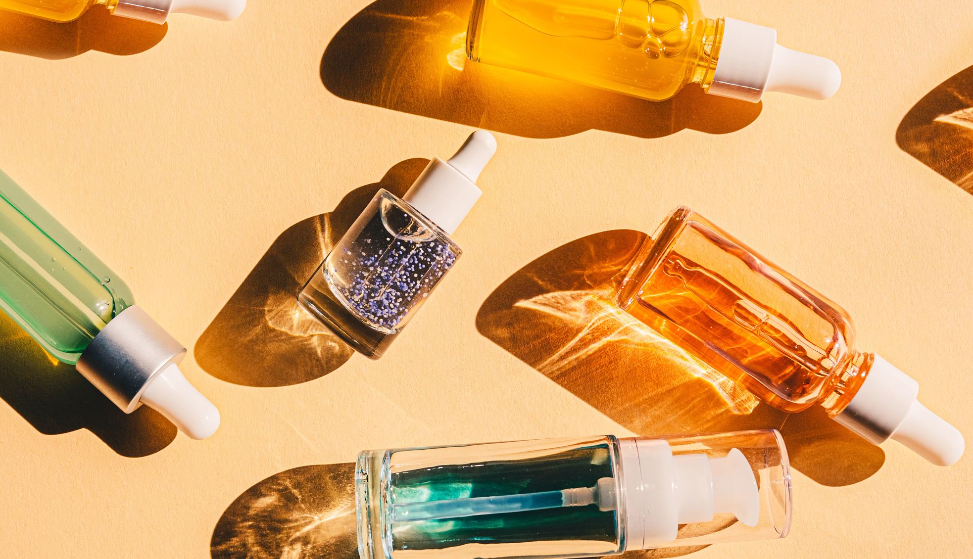 Anti-Aging Skincare Serums bottles of skincare serums on an orange background