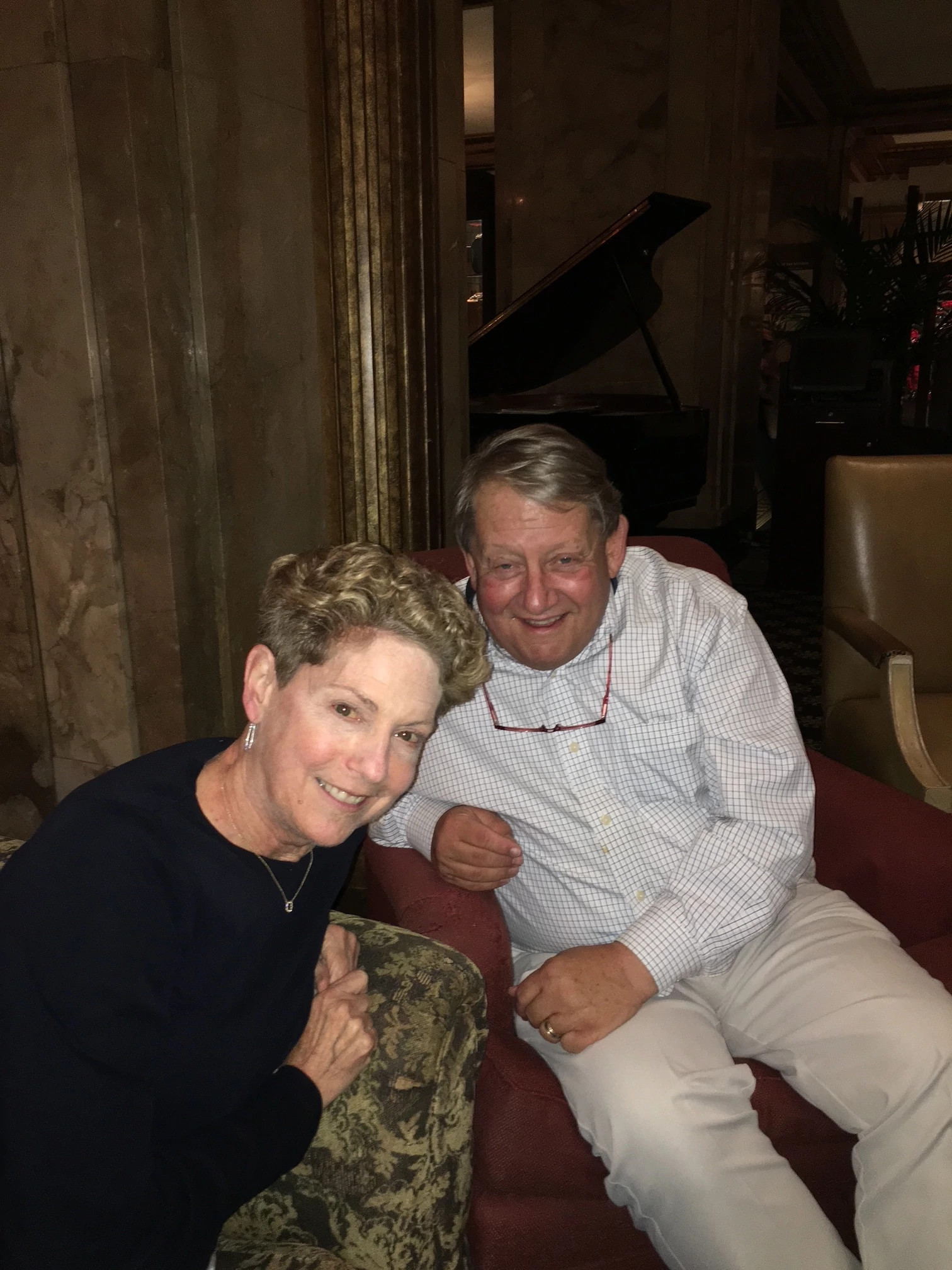 a man and woman, sitting in side by side chairs