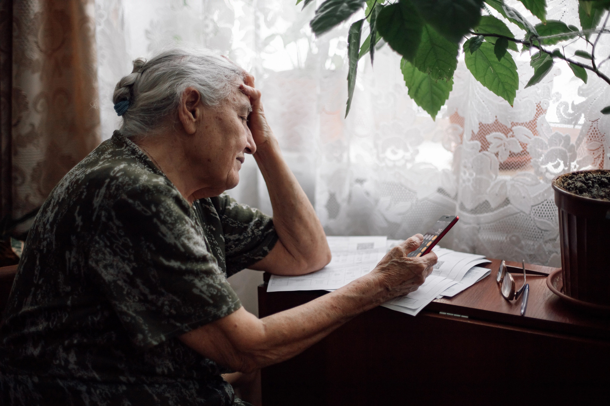 a person looking at bills