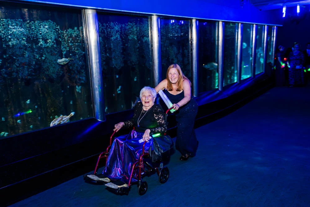 a photo shows author Lisa Suhay and her mother at a 2025 wedding held at the Virginia Beach Aquarium