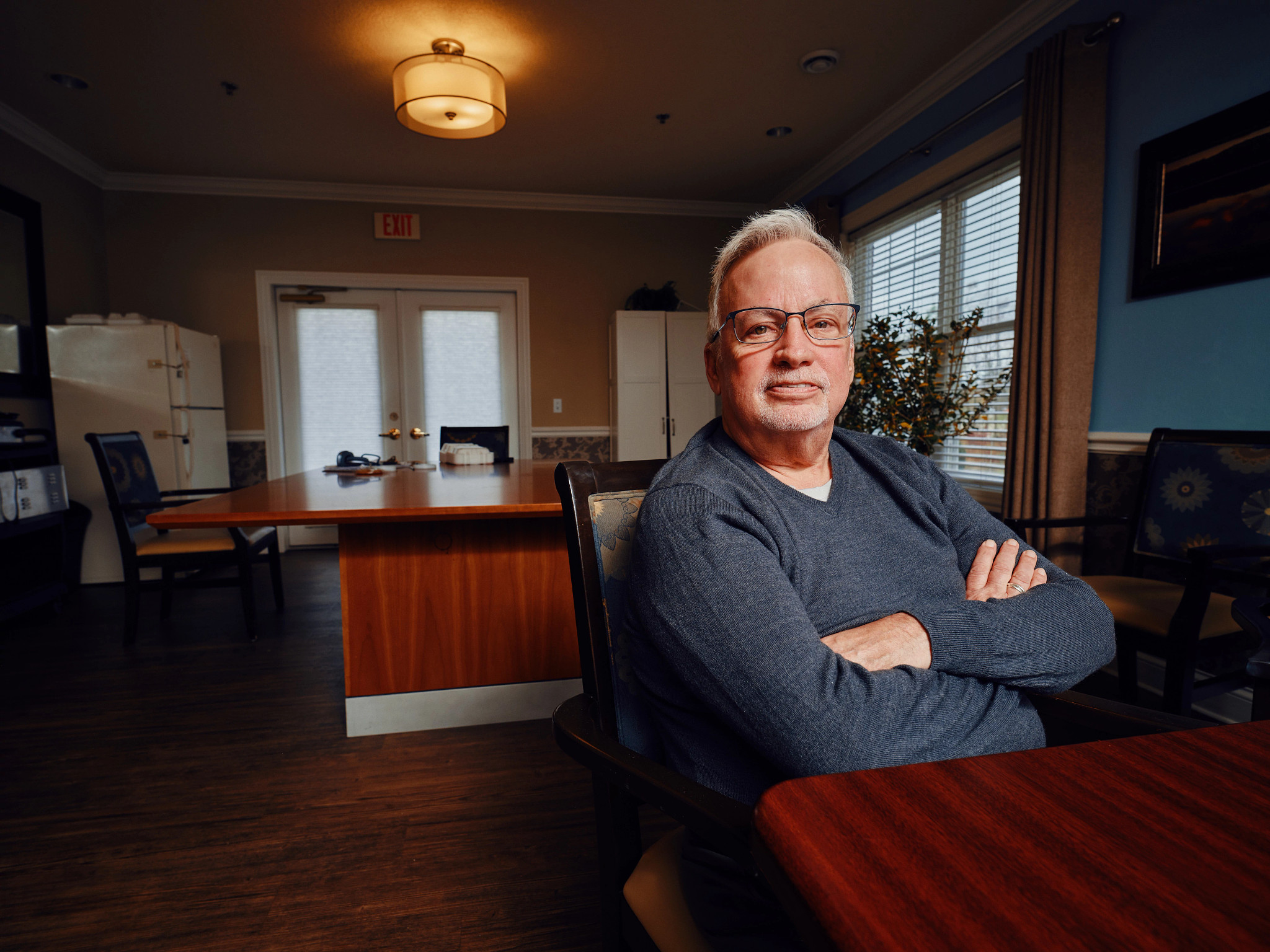 a man sits at a kitchen table