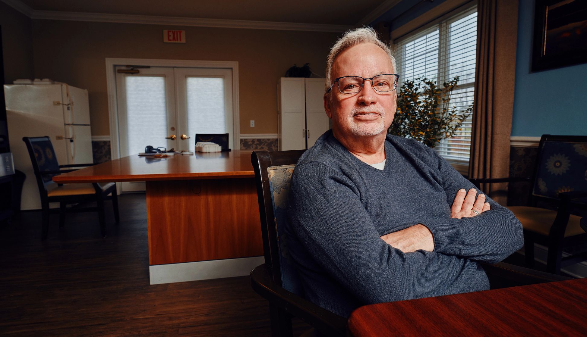 Mark Adamek a man sits at a kitchen table