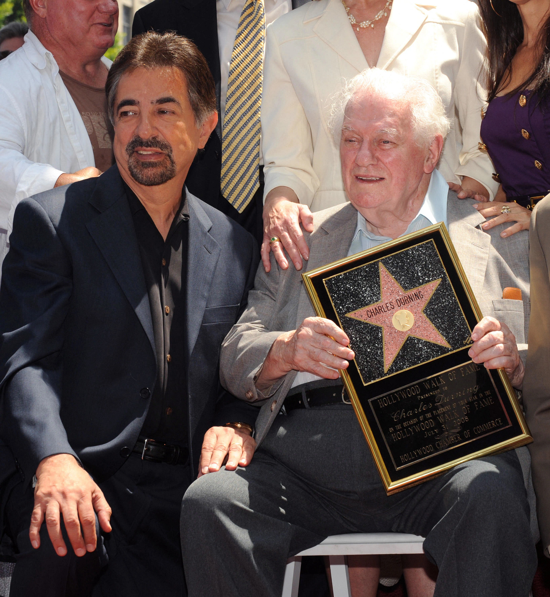 joe mantegna sitting with charles durning, who is holding his hollywood walk of fame plaque