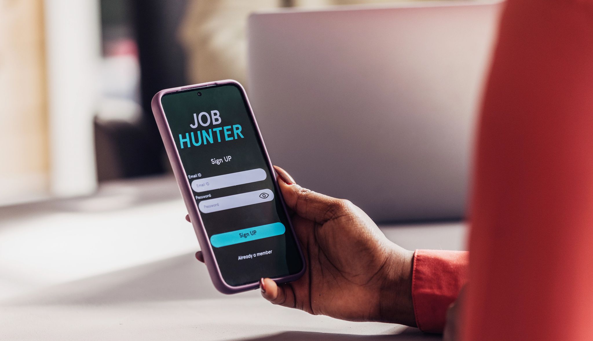 Smart Guide to Getting Hired a person holding a phone with job hunter on the screen