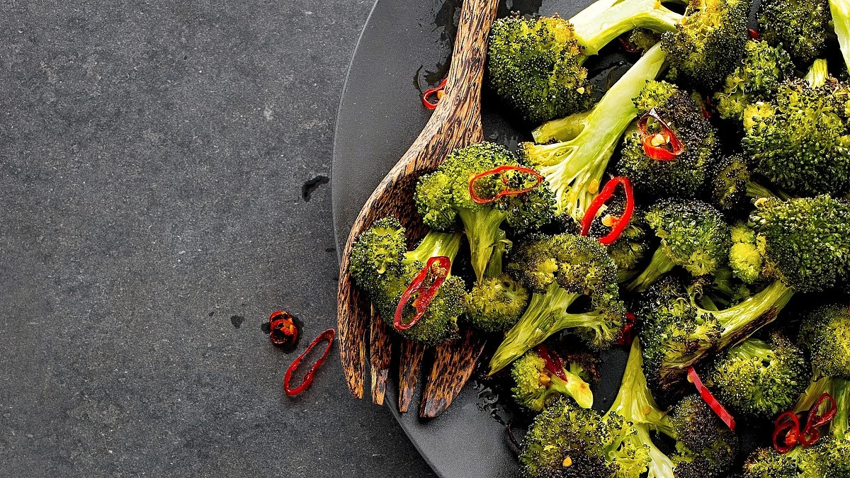 A close-up view of chile-roasted broccoli on a plate