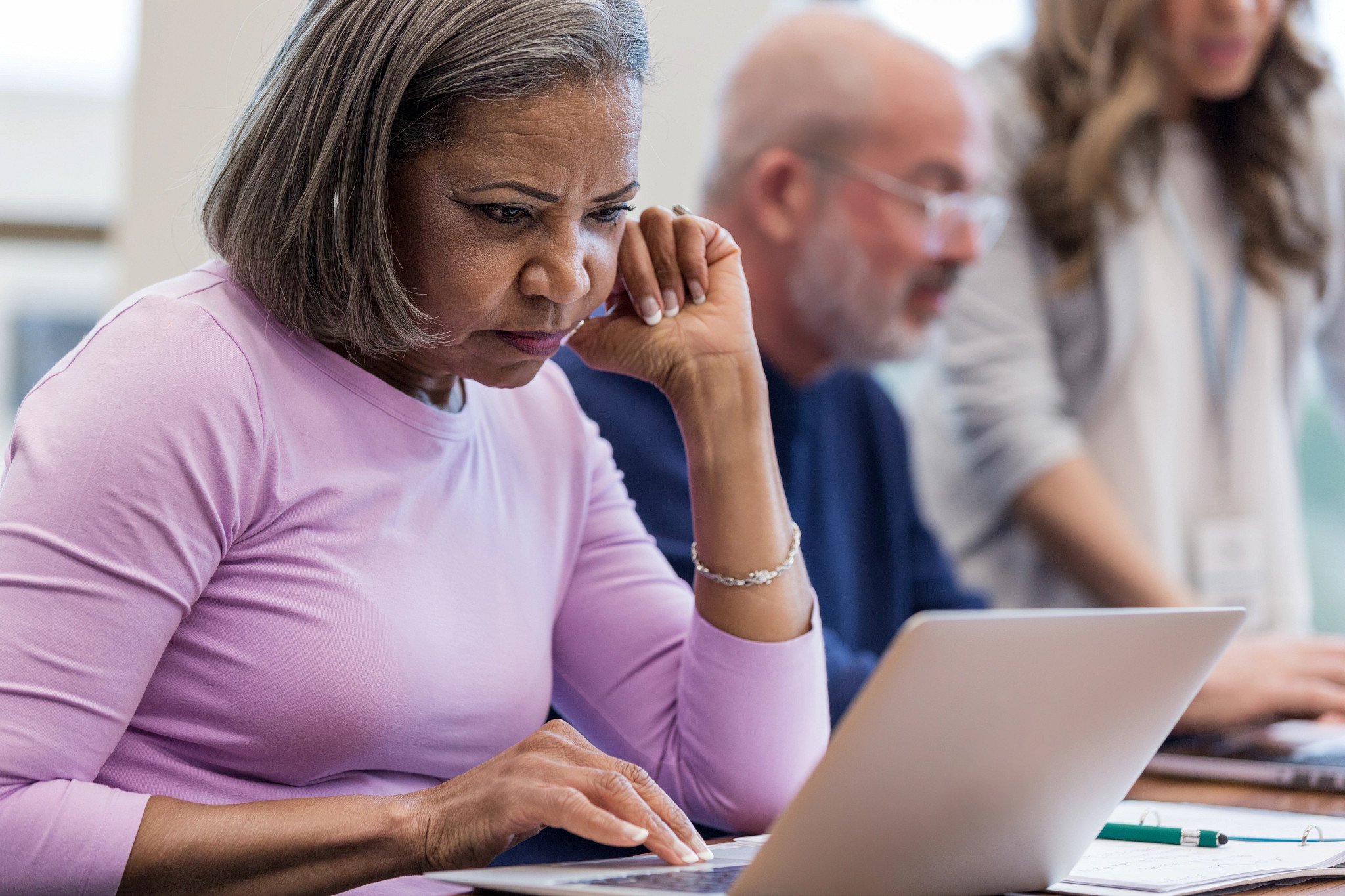  A mature adult woman concentrates on an assignment
