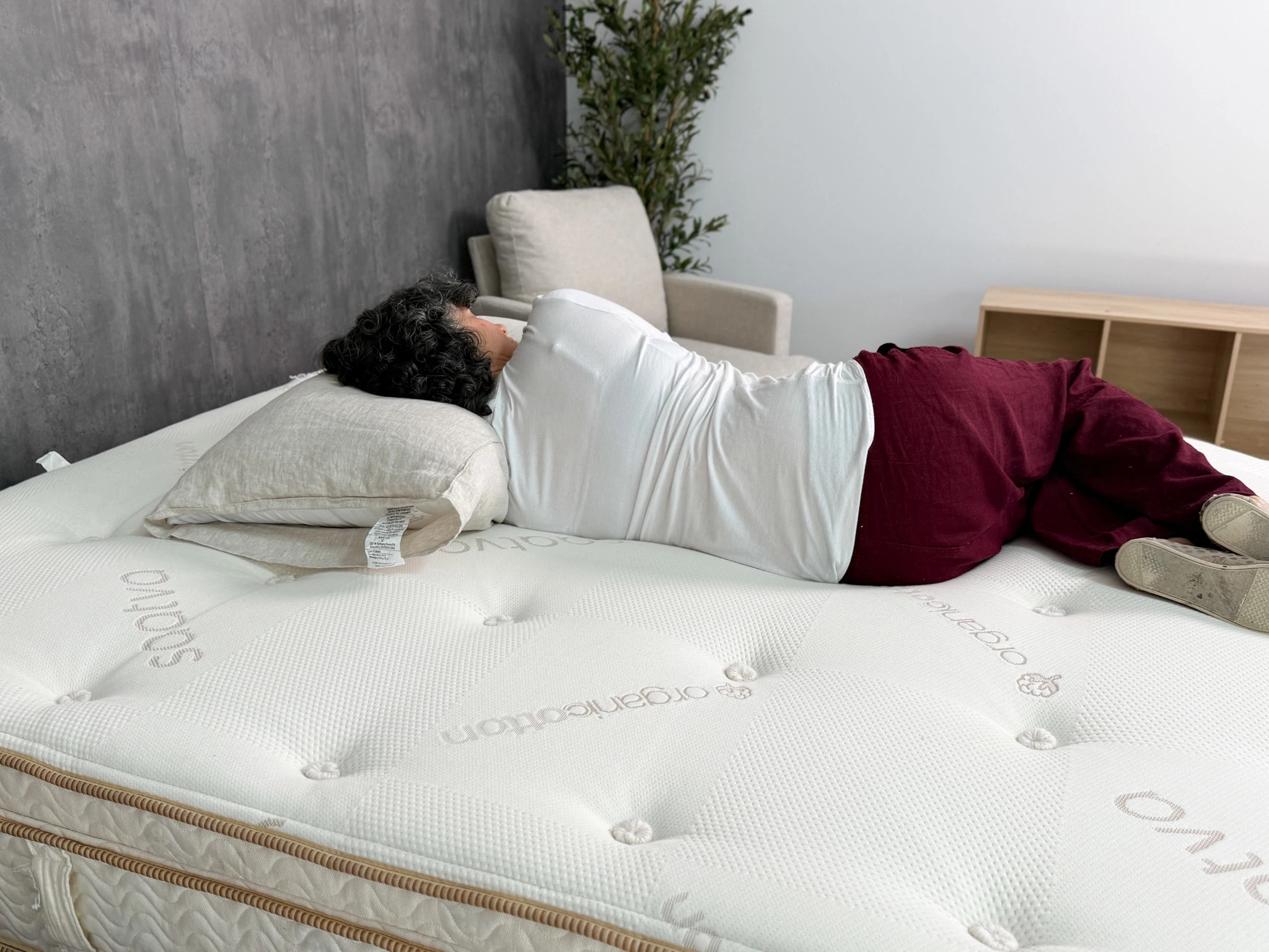 A woman sleeps on her side on the Saatva Latex Hybrid mattress