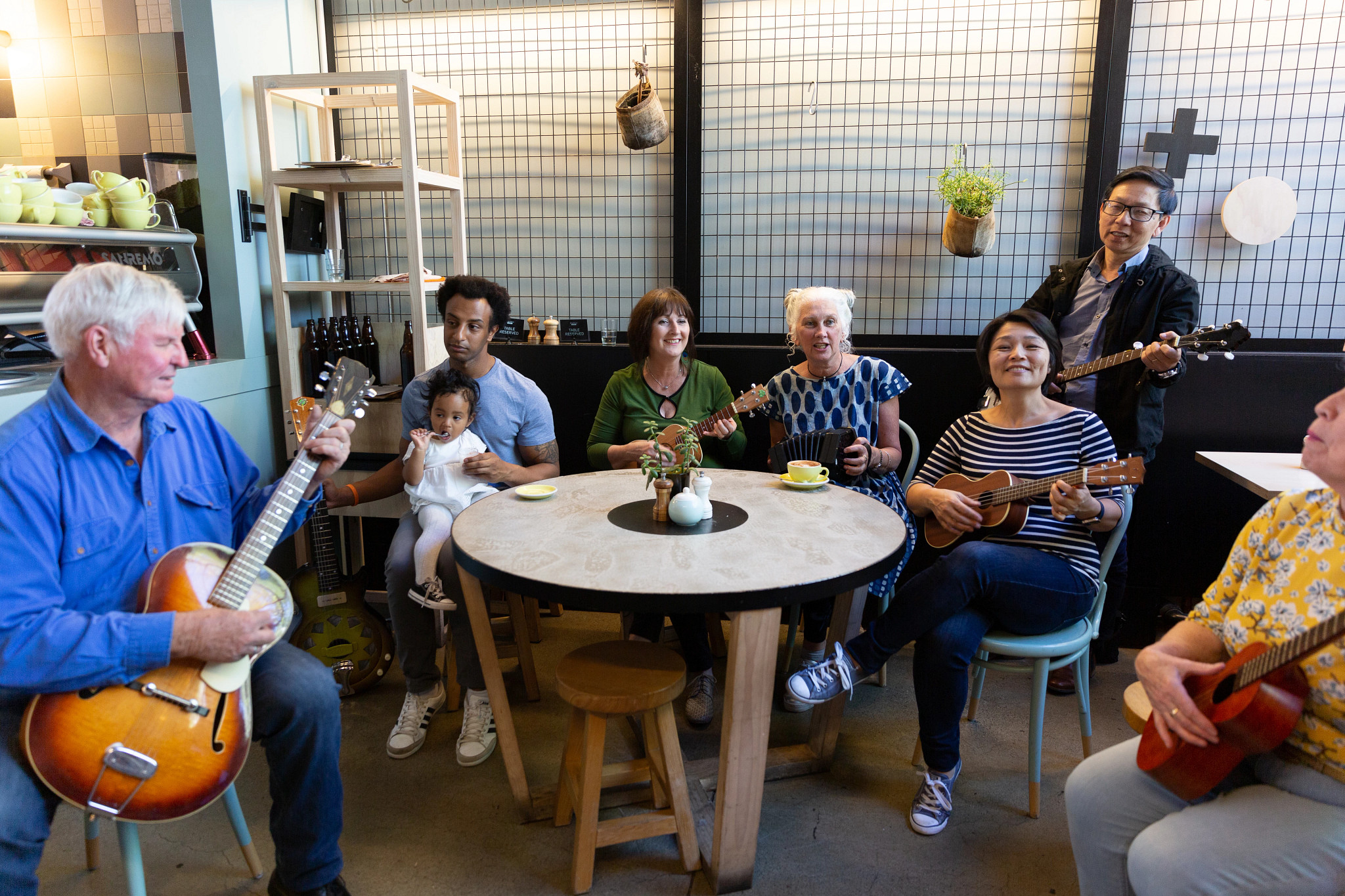 Group of friends of all ages making music together