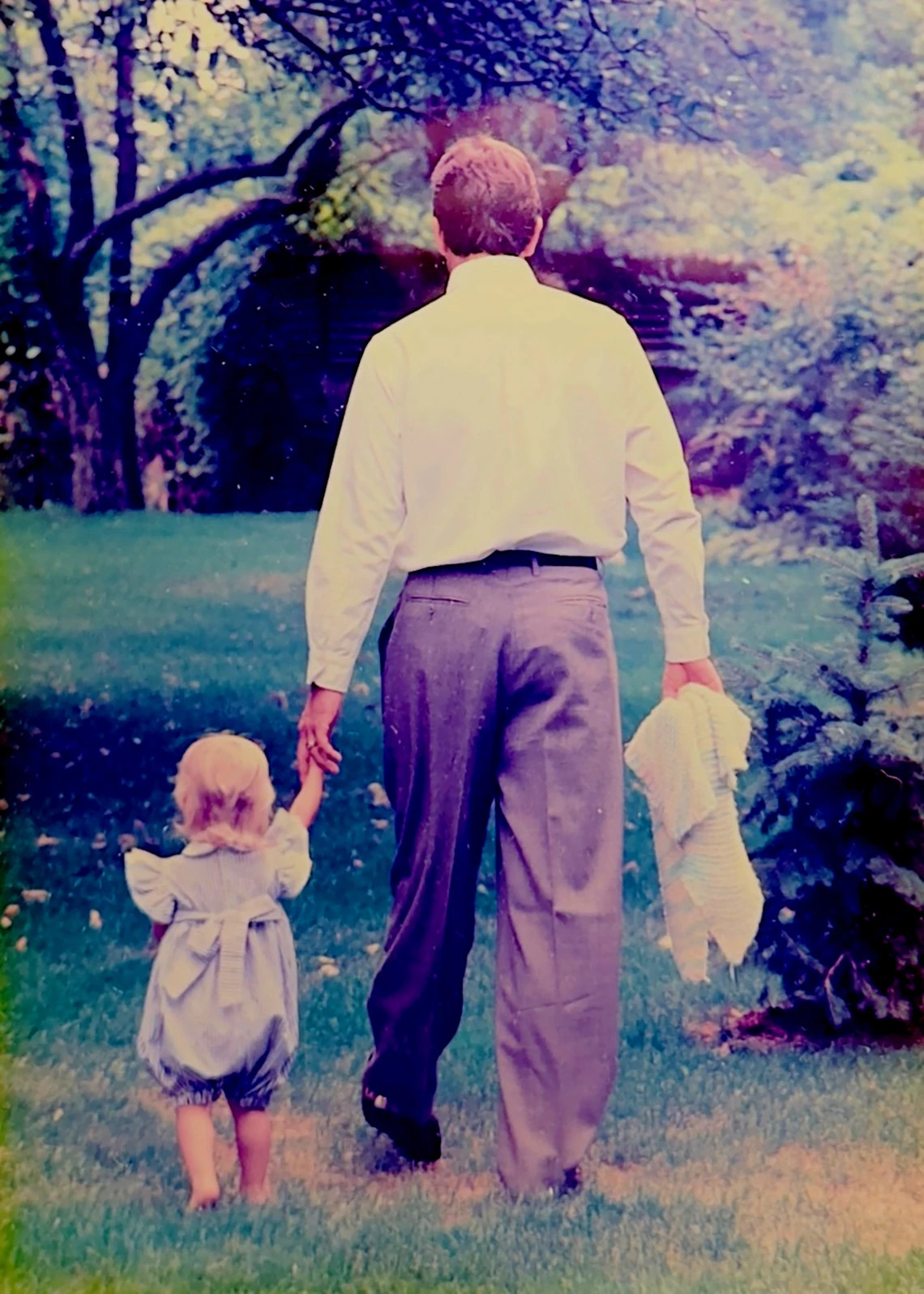 A photo shows Tim and his first daughter, Katherine, in the early '90s.