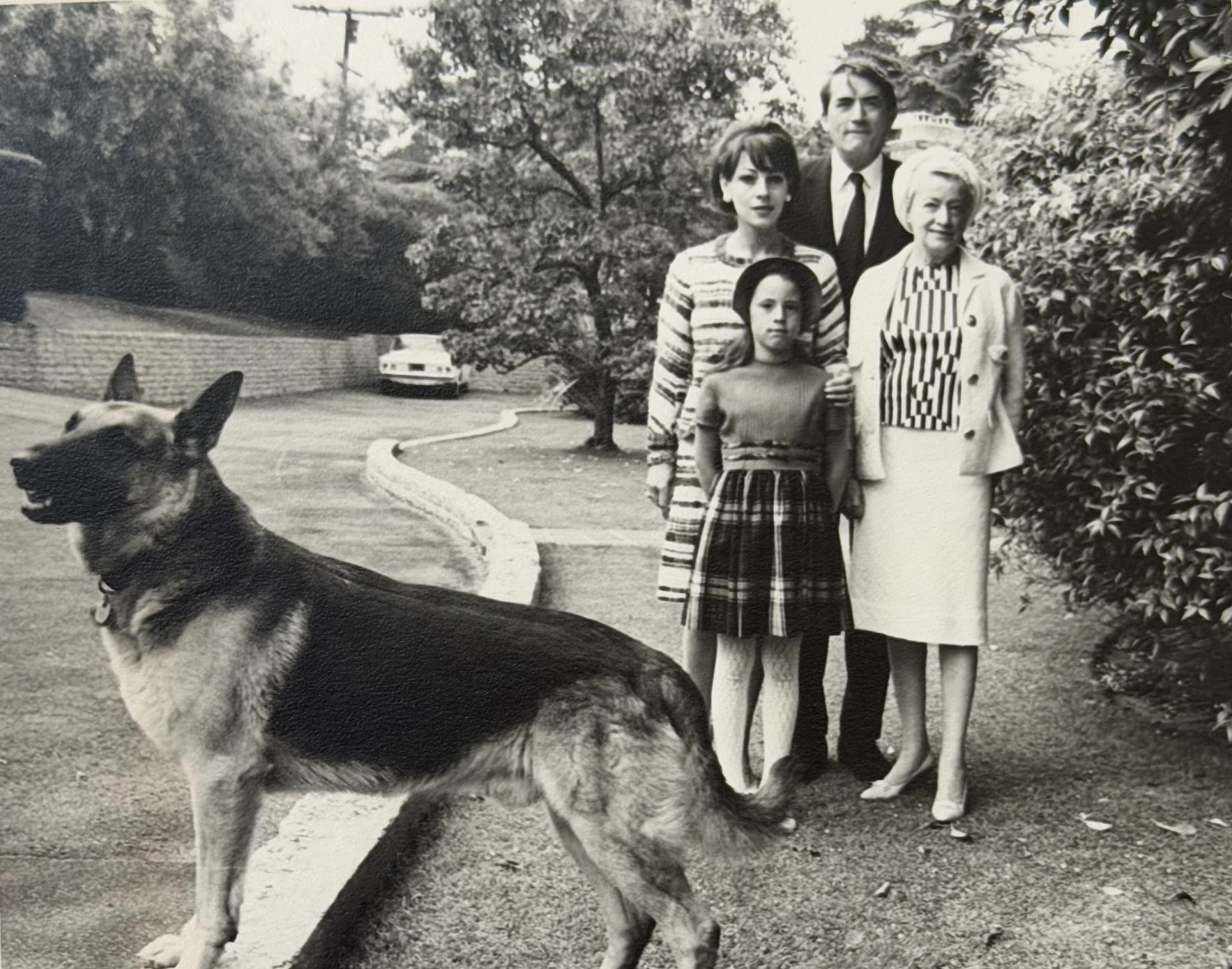 a photo shows Gregory Peck, wife Veronique, mother Bernice and daughter Cecilia and their dog Shawn in 1965