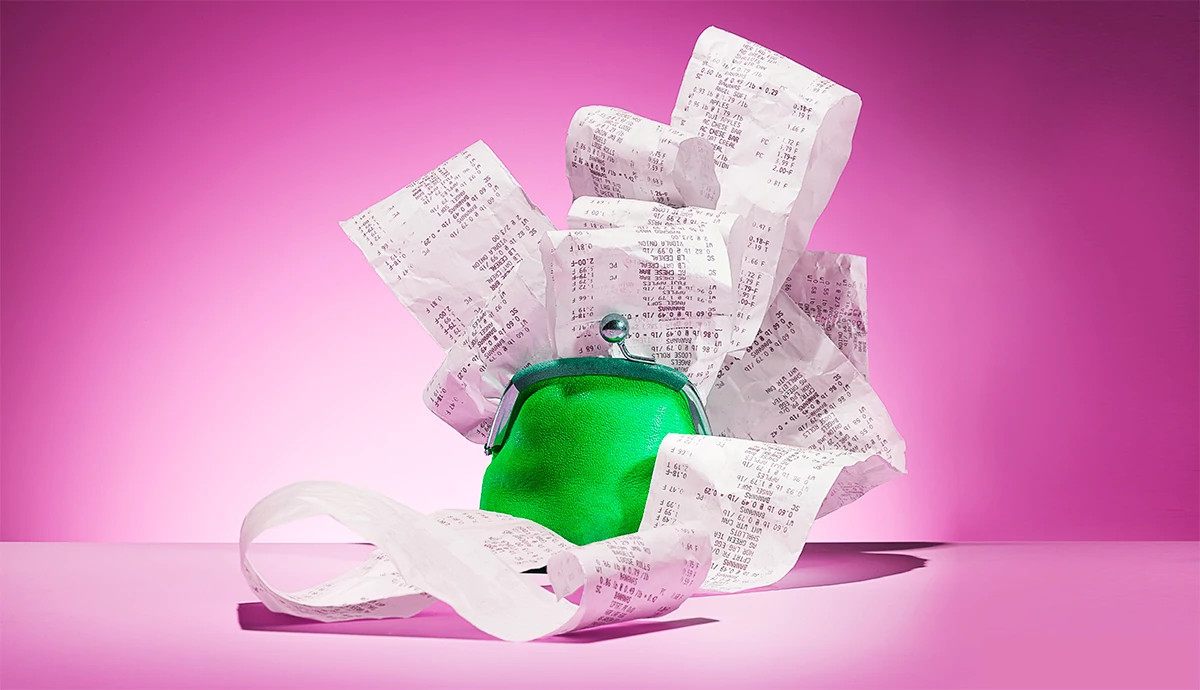 A long receipt spills out of a clutch purse