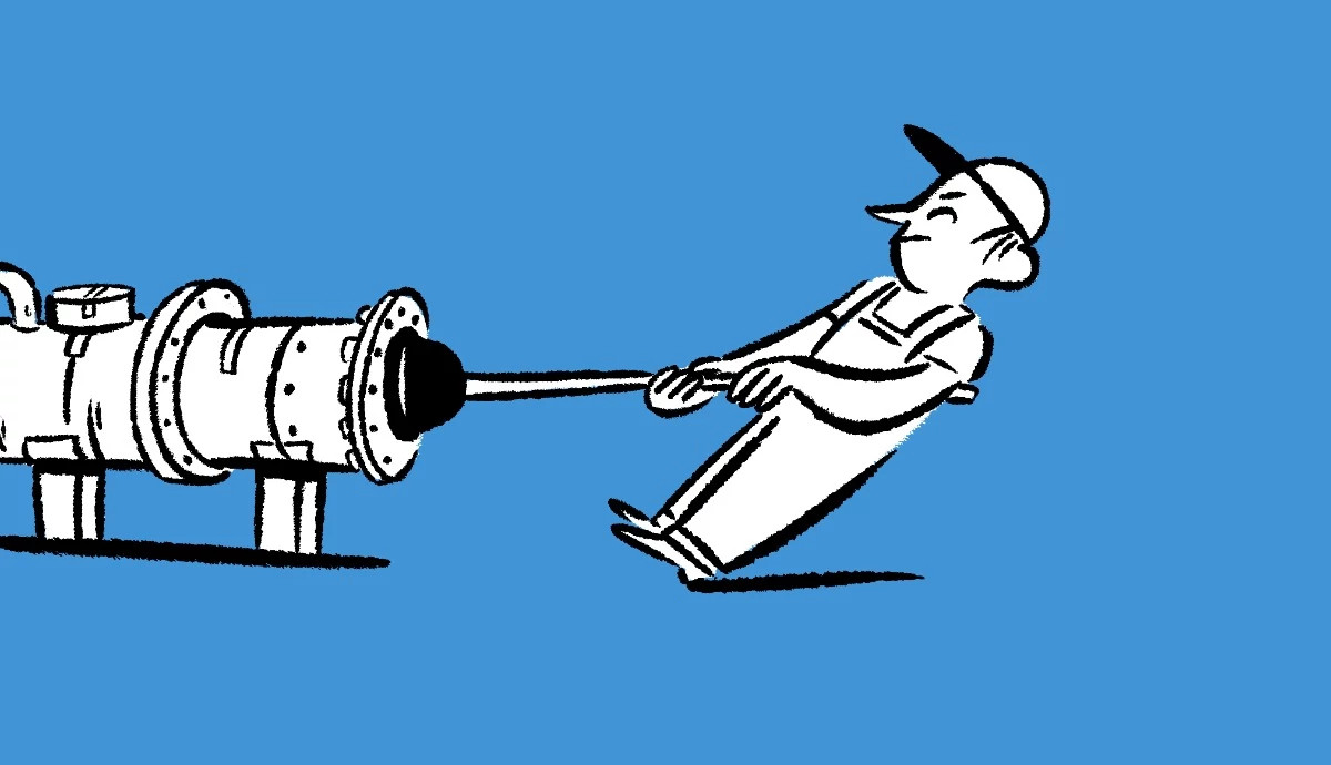 An illustration on a blue background shows a plumber wearing overalls and a baseball cap leaning back and straining to pull a large plunger out of a industrial pipe.