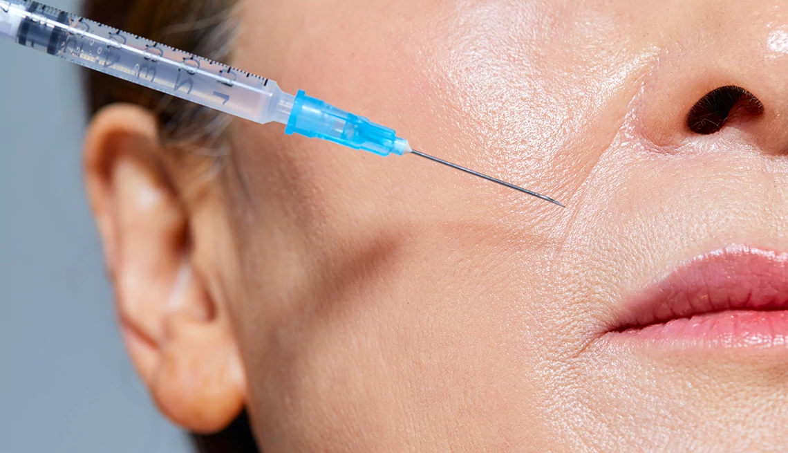 Wrinkle Management Tips a person receiving a facial injection