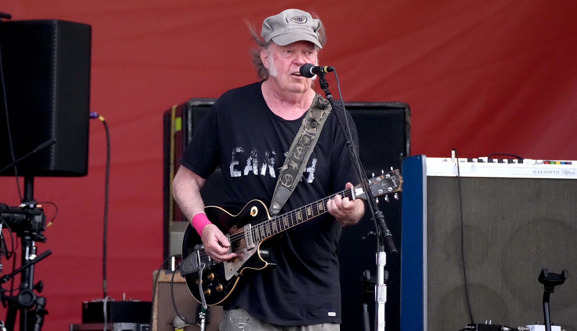 Neil Young at the 2024 New Orleans Jazz and Heritage Festival Neil Young playing an electric guitar onstage while singing into a microphone at the 2024 New Orleans Jazz and Heritage Festival
